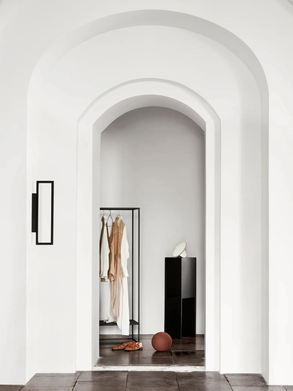 Kristina Dam Geometric Wall Lamp, a striking modern minimalist wall light crafted from matte black metal, featuring a clean rectangular open frame design that casts ambient light. This contemporary wall sconce offers a bold yet understated aesthetic, perfect for adding architectural interest to Scandinavian entryways, industrial chic living rooms, or modern bedrooms.