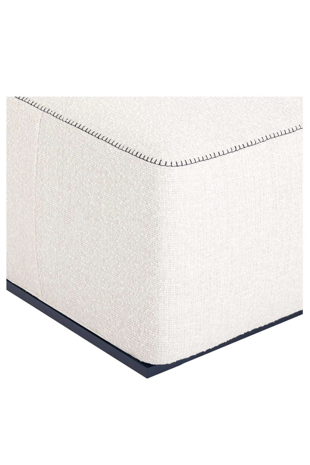 Gandia Blasco Islablanca Outdoor Pouf, a modern rectangular outdoor pouf upholstered in a cream-colored textured outdoor fabric with prominent dark navy contrast stitching along the edges, set on a sleek dark navy metal base.