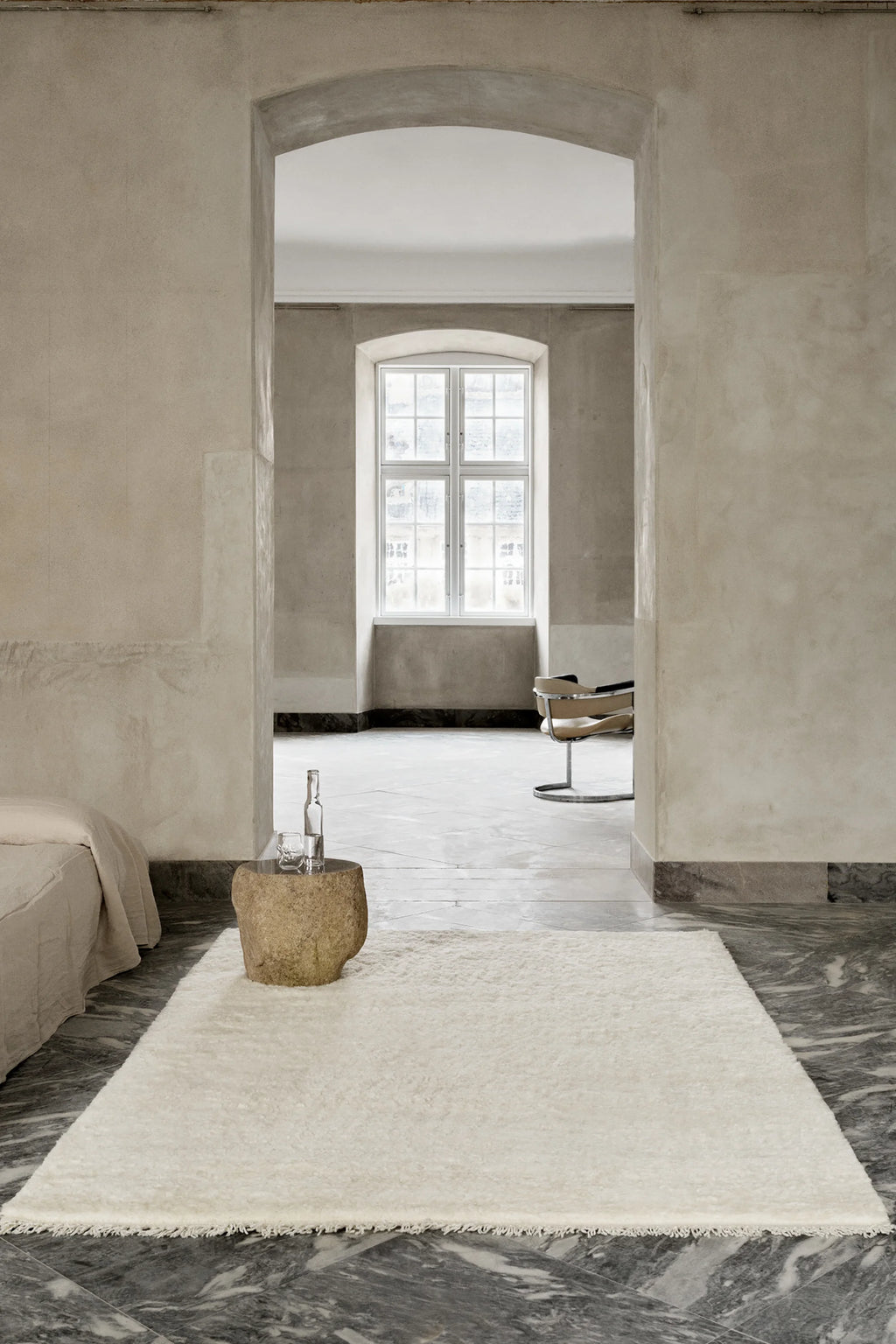 Linie Design Soft Savannah Wool Rug, a plush hand-knotted wool area rug in a natural cream and off-white color, featuring a soft, shaggy texture and rectangular shape. This cozy, minimalist rug is perfect for adding warmth to Scandinavian living rooms, organic modern bedrooms, or japandi-inspired spaces.