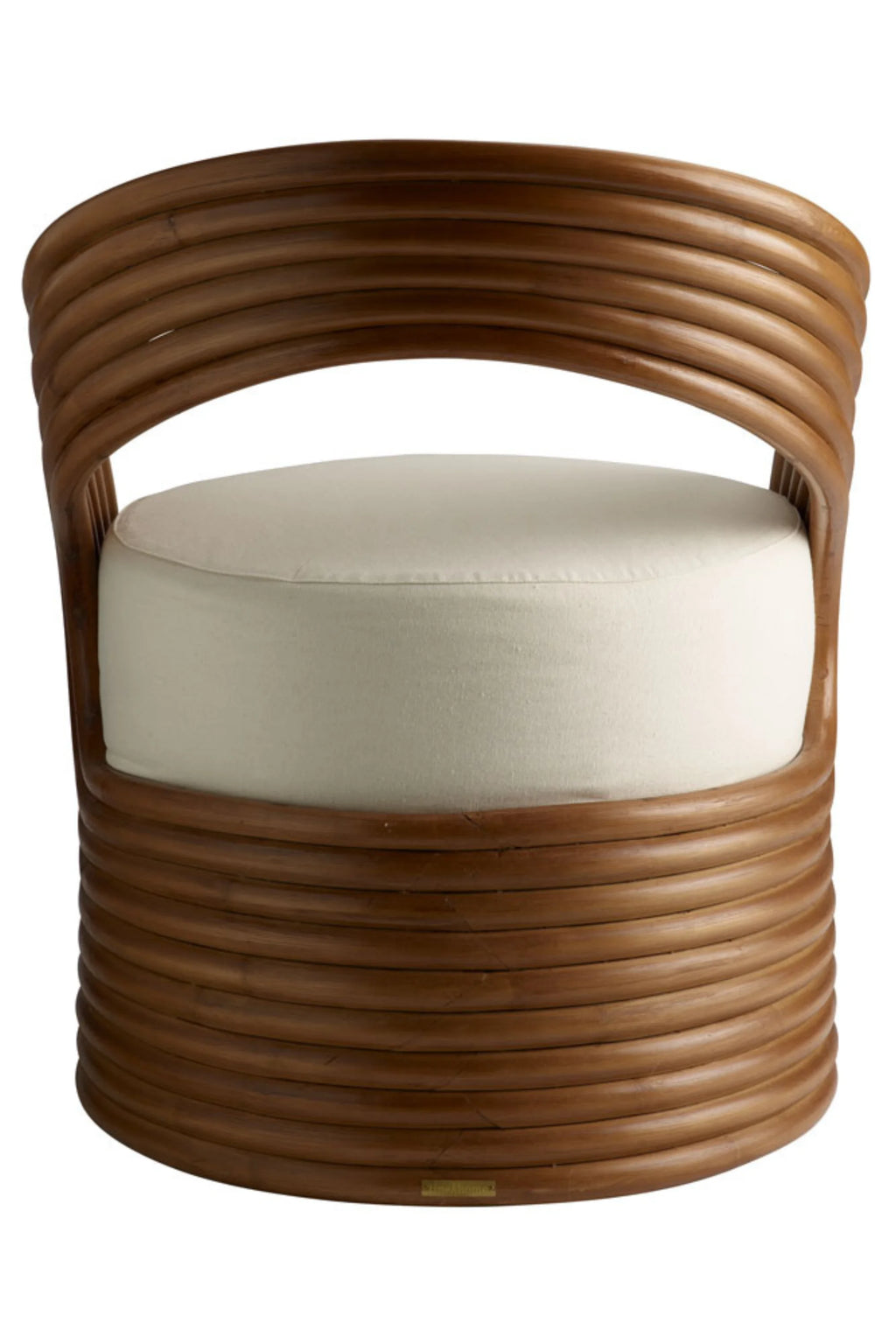 Tine K Mano Armchair, a contemporary lounge chair crafted from curved natural brown rattan poles, forming a distinctive barrel silhouette with an open backrest design. It features a plush, removable off-white fabric cushion for comfortable seating. This organic modern armchair is perfect for coastal living rooms, boho bedrooms, or as a stylish accent chair in Scandinavian-inspired spaces.