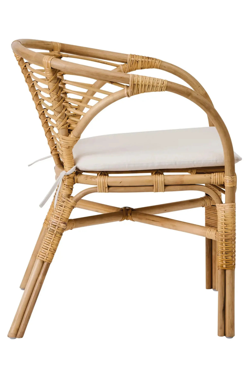 Tine K Dola Rattan Chair - Set of 2, a natural blonde rattan dining chair featuring a gracefully curved frame with intricate hand-woven rattan detailing and a comfortable cream fabric seat cushion. This organic modern and coastal-inspired design provides a relaxed aesthetic, ideal for Scandinavian dining rooms, bohemian living spaces, or covered patio seating.