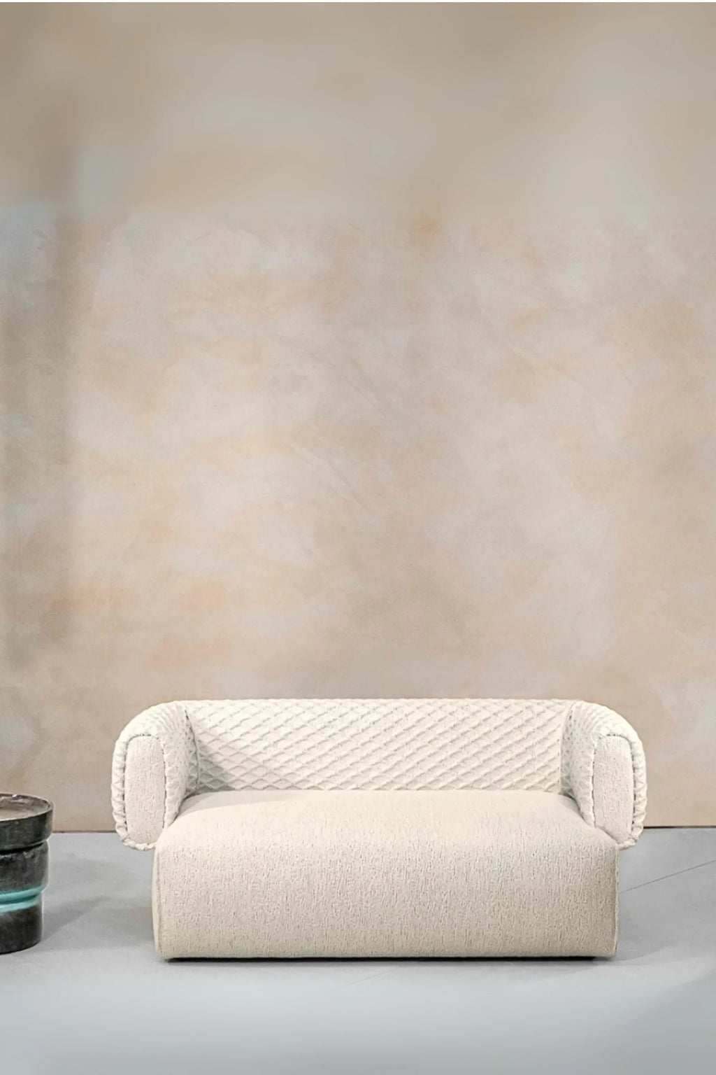 Hessentia Hug Sofa, a contemporary cream bouclé sofa featuring a plush, textured fabric upholstery and a distinctive quilted diamond-patterned backrest with softly curved arms. This organic modern loveseat offers a cozy, low-profile design ideal for minimalist living rooms, elegant accent seating, or a chic reading nook.