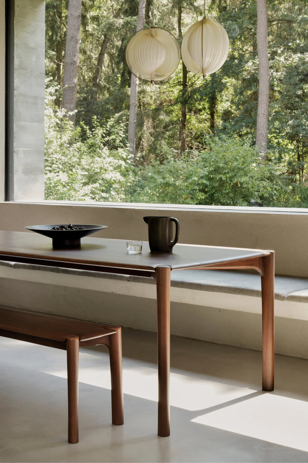 Ethnicraft PI Dining Table, a modern solid wood dining table featuring a dark brown rectangular tabletop with subtly rounded corners, supported by elegant, organically shaped solid wood legs in a warm, natural finish. This contemporary wooden dining table embodies minimalist design with its clean lines and sturdy construction, ideal for a Scandinavian dining room, organic modern kitchen, or sophisticated open-plan living space.