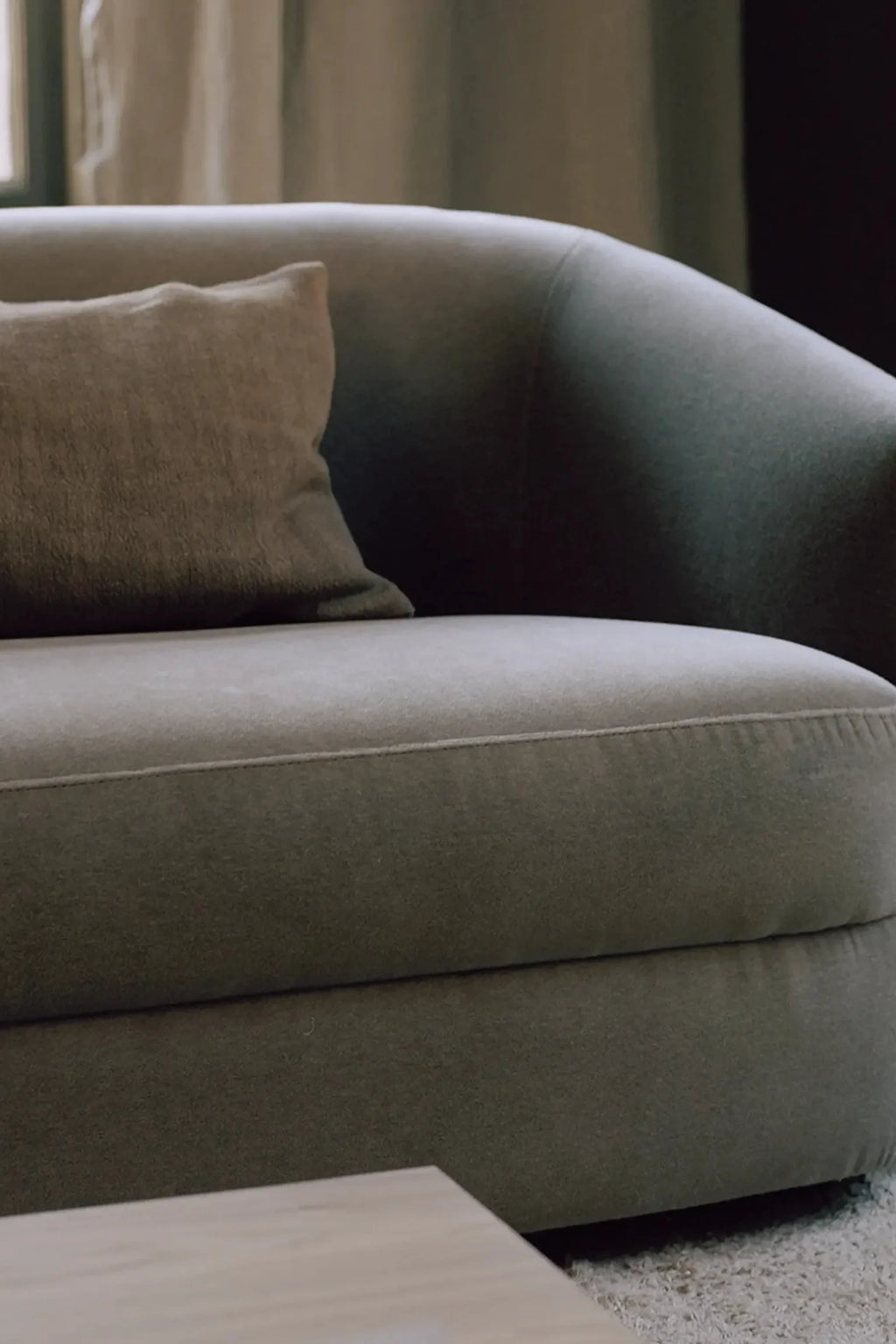 New Works Covent Sofa Narrow 2-Seater, a contemporary 2-seater sofa upholstered in a soft, muted greige fabric with a gently curved backrest and deep, plush seating.