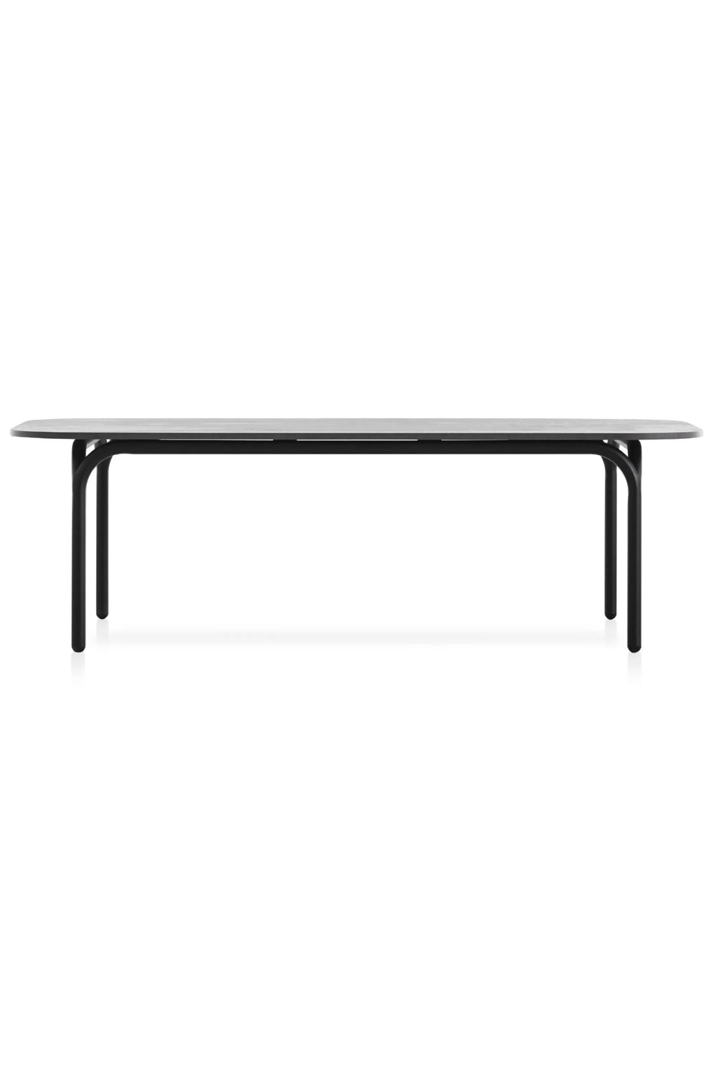 Gandia Blasco Capa Coffee Table, a modern minimalist outdoor table featuring an elongated racetrack oval dark grey compact top and a sleek matte black aluminum frame with rounded tubular legs. This contemporary patio coffee table offers durable construction and clean lines for a sophisticated aesthetic. Ideal for modern outdoor living spaces, garden lounges, or terraces.