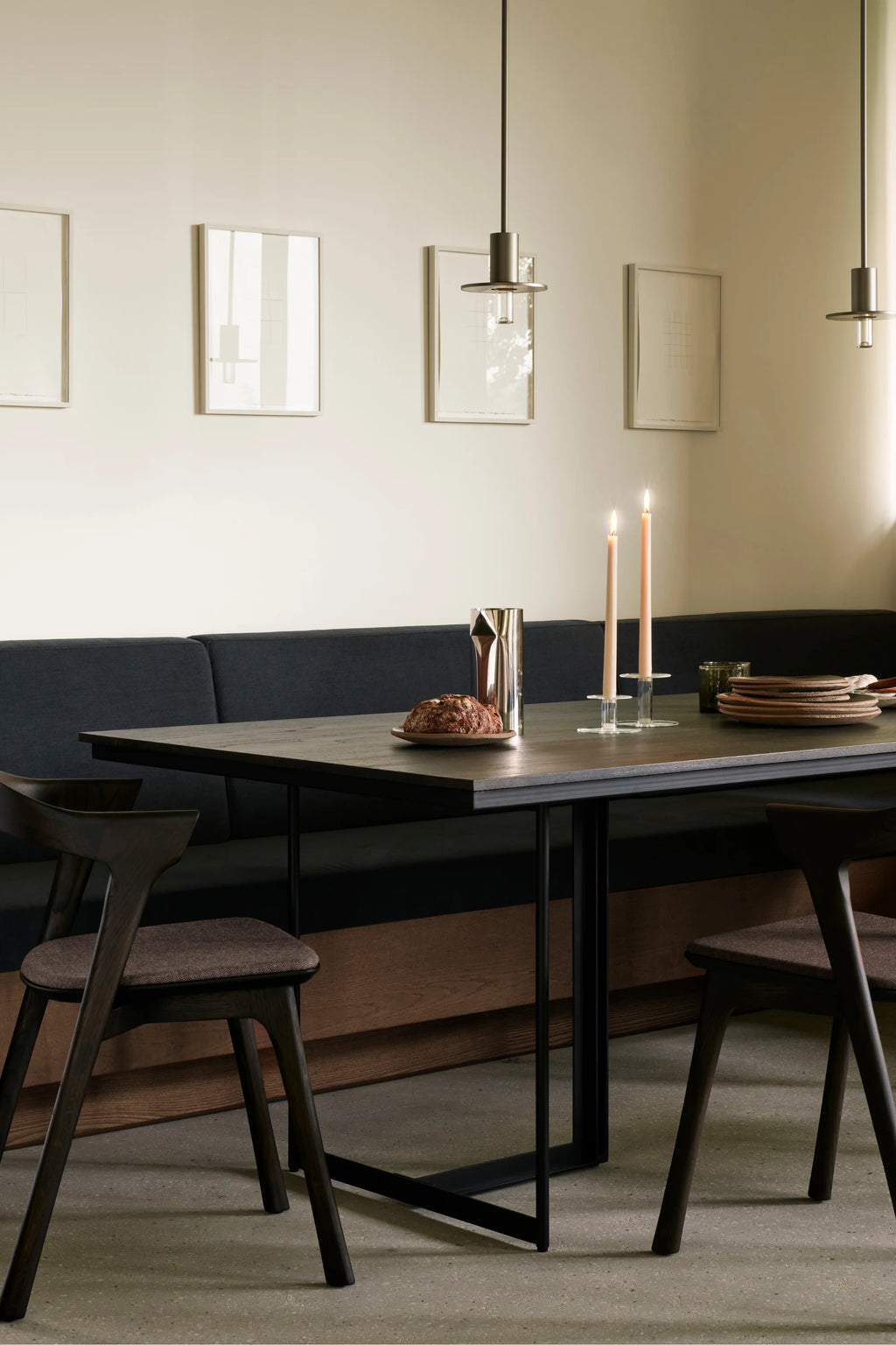 Ethnicraft Tacet Dining Table, a modern minimalist rectangular dining table featuring a dark solid oak wood tabletop with clean lines and a sturdy matte black metal base. This contemporary dining table is perfect for stylish dining rooms and industrial chic kitchens, offering a sleek design for everyday meals or entertaining.