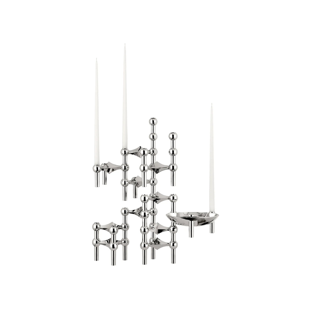 Stoff Nagel Modular Candle Holder - Chrome - Configuration 1, a striking mid-century modern candelabra crafted from polished chrome-plated metal with a modular, sculptural design featuring spherical joints and cylindrical arms, holding three white taper candles. This iconic Danish design piece serves as a minimalist metallic centerpiece for dining tables or a stylish accent for contemporary living rooms.
