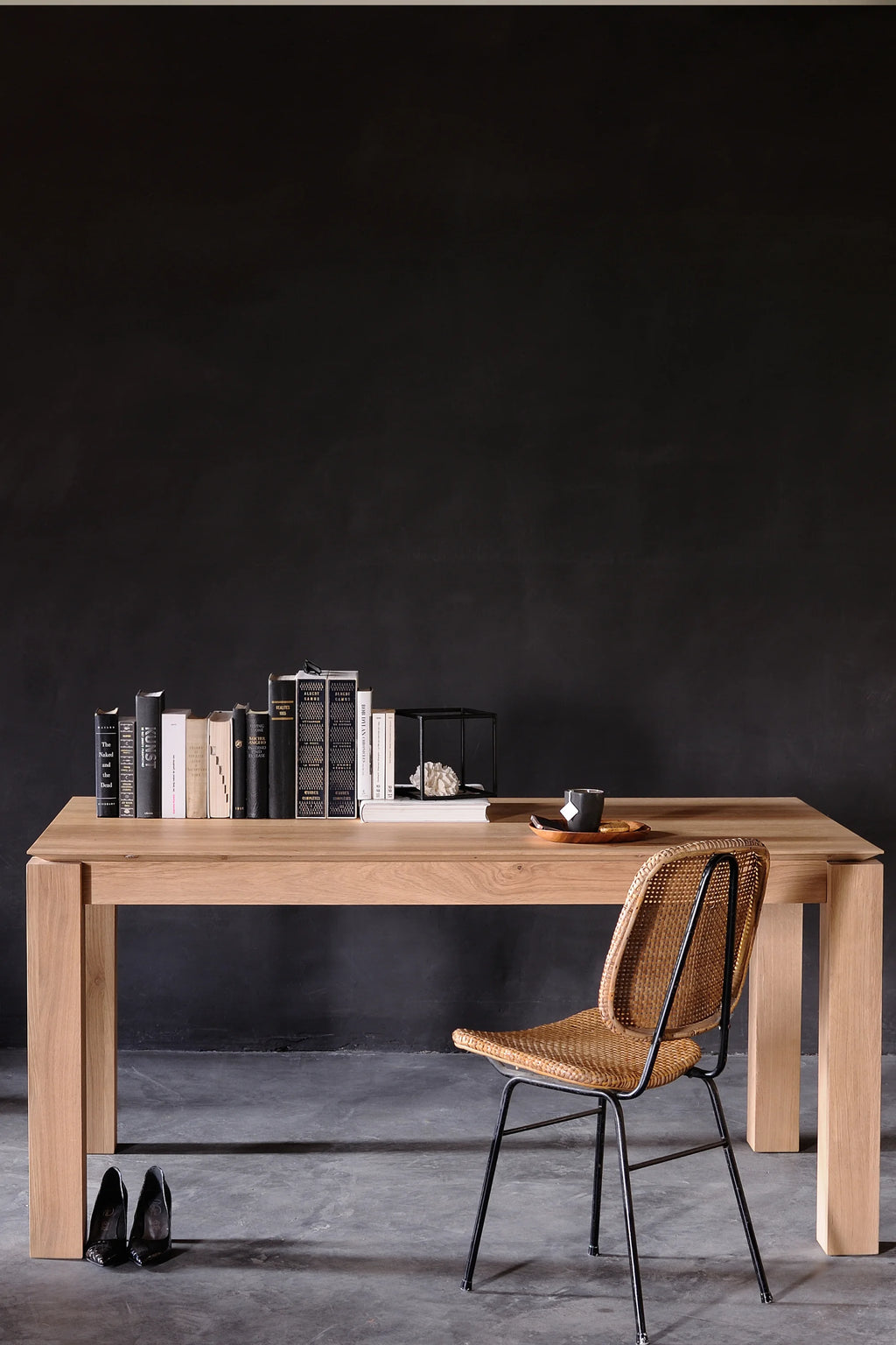 Ethnicraft Slice Dining Table, a modern minimalist solid oak dining table crafted from natural light oak wood with a visible grain and a smooth finish. This rectangular wood dining table features thick, sturdy legs and clean lines, perfect for contemporary Scandinavian dining rooms and open-plan kitchen spaces.
