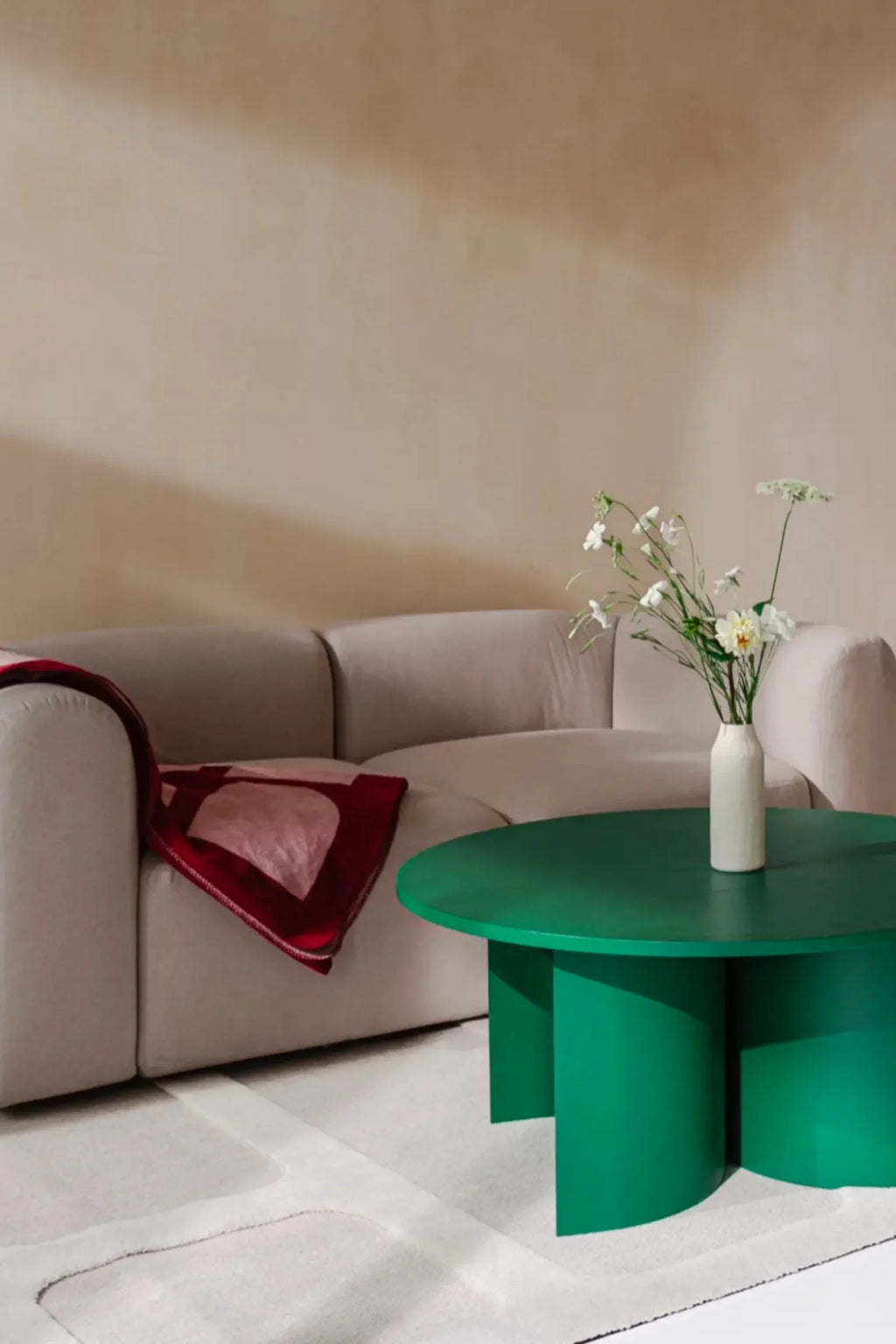 noo.ma Flom 2-Seater Sofa, a contemporary organic modern sofa upholstered in a light beige fabric with a distinctive curved silhouette and plush, rounded arms. This minimalist 2-seater sofa is perfect for small living rooms or adding a soft, inviting touch to Scandinavian-inspired interiors.