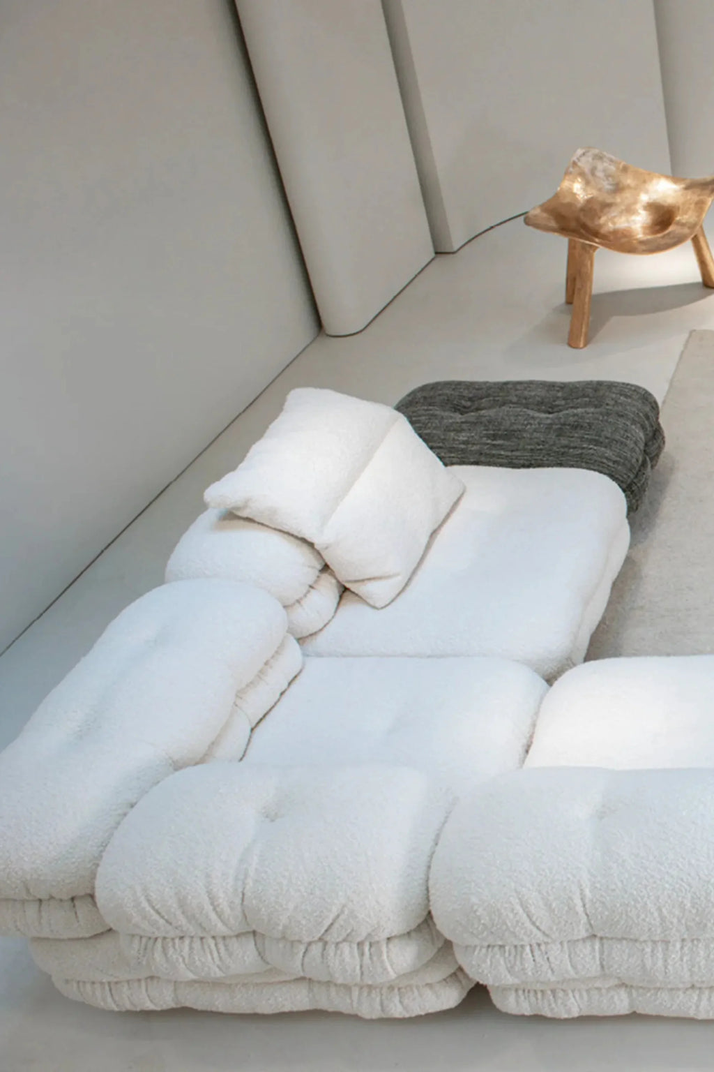 Hessentia Lowell Modular Sofa, a contemporary low-profile modular sofa upholstered in plush, textured cream bouclé fabric, featuring deep, soft, pillowy cushions and a relaxed, organic modern silhouette.