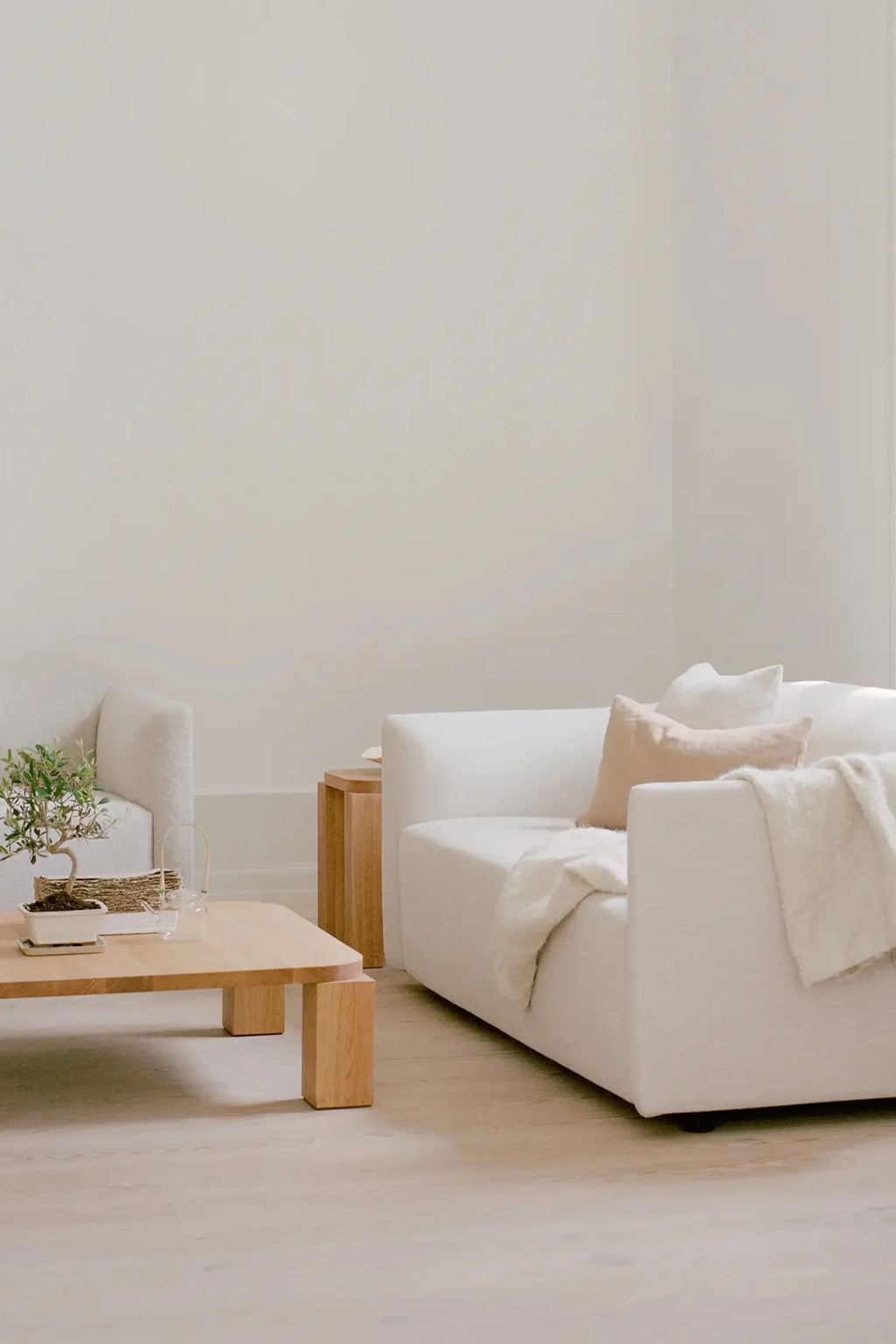 New Works Shore Sofa 2-Seater - Extended Base, a modern minimalist sofa featuring a plush, textured cream-colored upholstery with a low-slung, blocky silhouette and softly rounded.