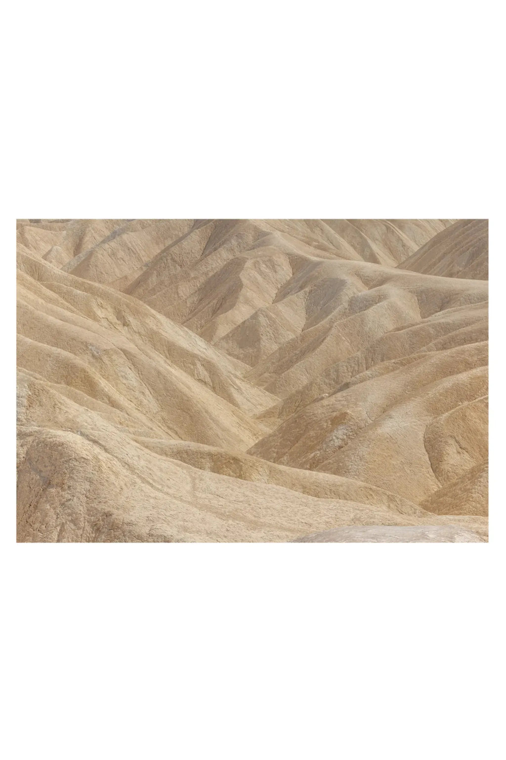 The Poster Club Perpetual, an abstract landscape art print featuring undulating desert hills and valleys in warm beige and sand tones, capturing the raw, textured beauty of natural terrain. This organic modern poster offers a minimalist aesthetic for contemporary gallery walls, wabi-sabi living rooms, or serene bedroom decor.