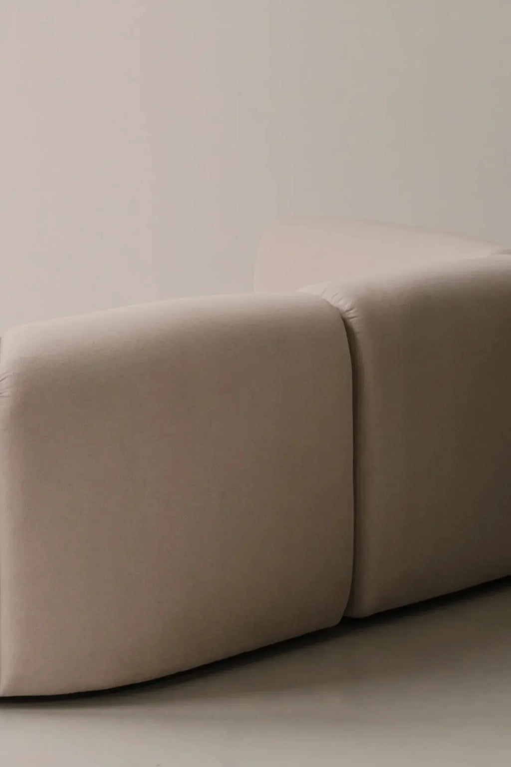 noo.ma Flom 2-Seater Sofa, a contemporary organic modern modular sofa upholstered in a soft, light greige textured fabric with a low-profile silhouette and rounded, plush cushions.