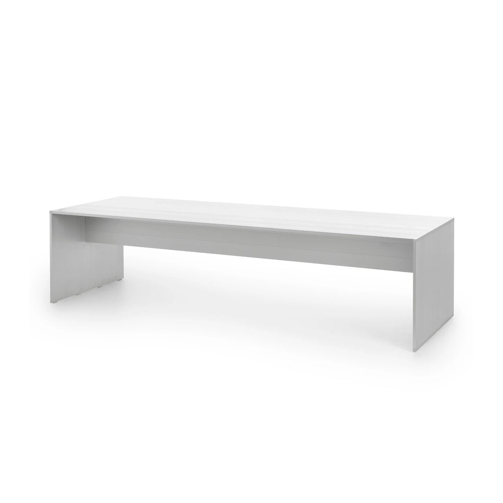 Gandia Blasco GBmodular Dining Table, a sleek modern minimalist outdoor dining table crafted from durable white aluminum with a matte finish, featuring a clean rectangular silhouette and architectural lines. The robust design includes a thick tabletop and solid, bench-like legs, creating a monolithic contemporary aesthetic. Ideal for modern patio dining, contemporary garden spaces, or minimalist outdoor entertaining.