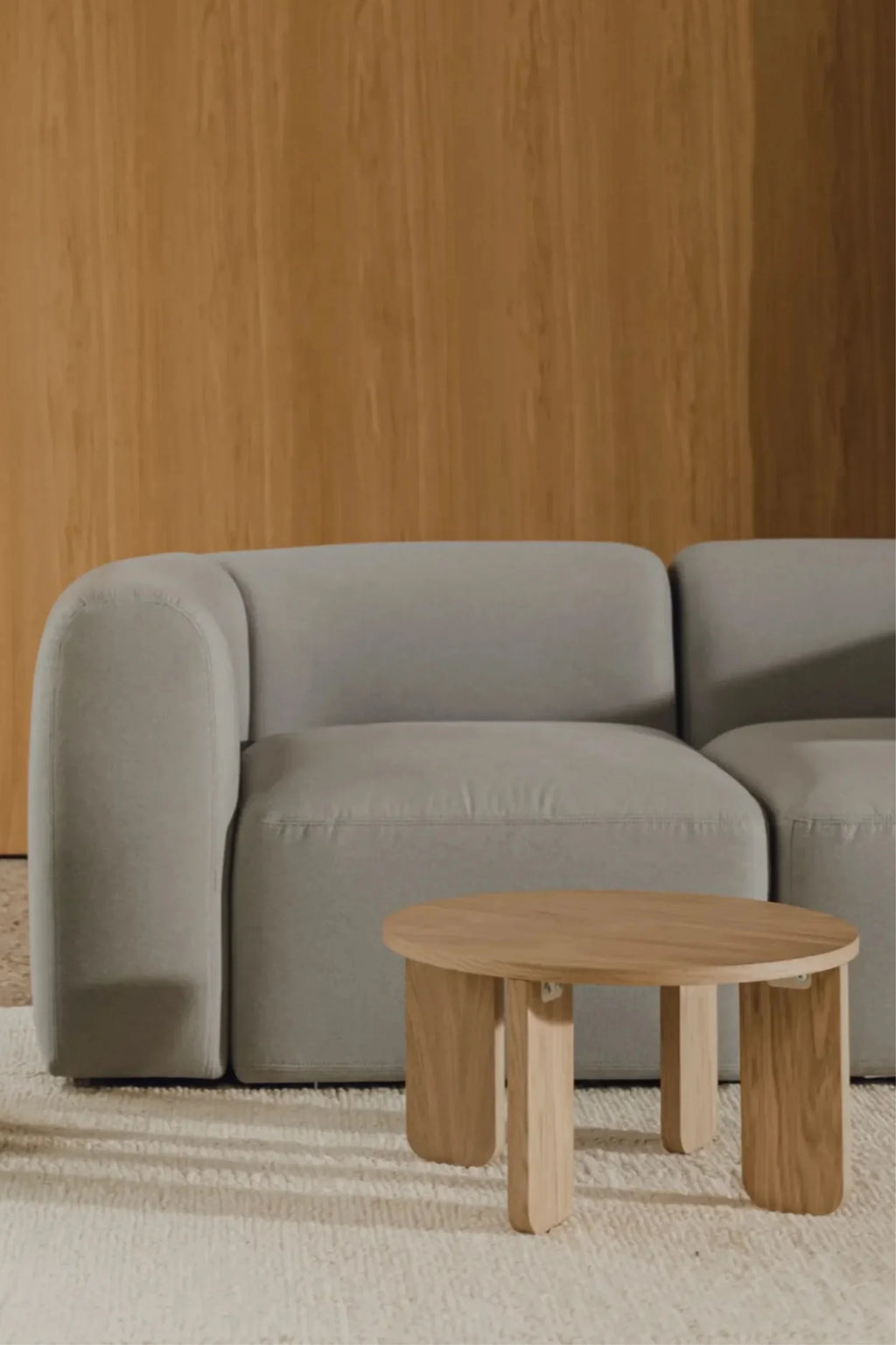 noo.ma Flom 3-Seater Sofa, a contemporary light grey modular sofa featuring plush, textured fabric upholstery and soft, rounded edges. This organic modern design offers a low-profile silhouette with deep, inviting seating, embodying minimalist Scandinavian style. It's an ideal focal point for a modern living room or a cozy, design-conscious lounge area.