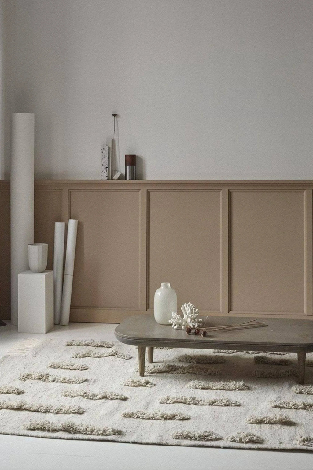Sera Helsinki Laine Rug, a luxurious hand-tufted wool area rug in a natural undyed cream color, featuring a unique textured design with abstract, shaggy raised tufts that create an organic wave-like pattern across its surface. This soft, cozy wool rug is perfect for adding warmth and Scandinavian or Japandi style to minimalist living rooms, bedrooms, or hygge-inspired spaces.