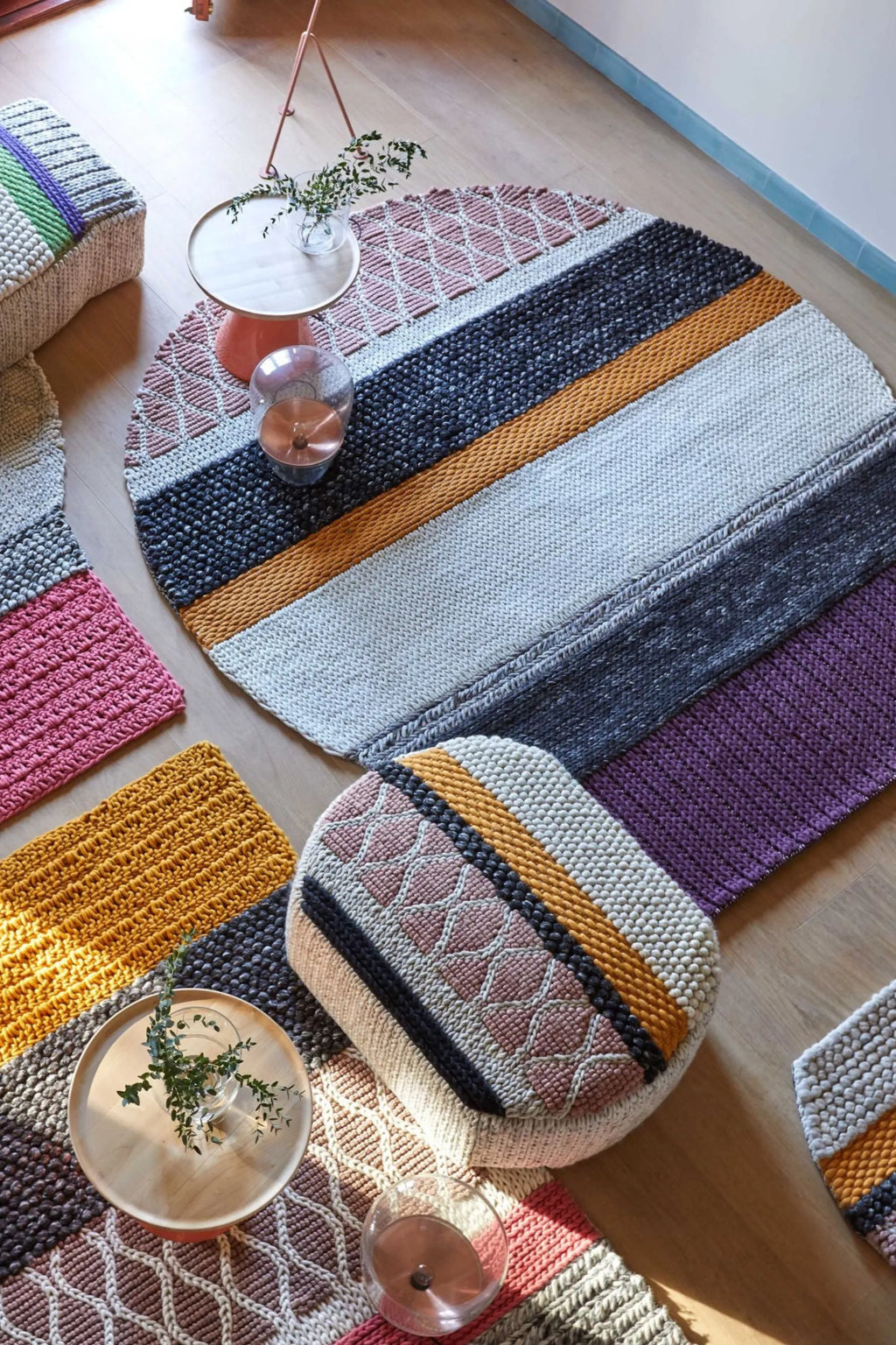 GAN Rugs Mangas Original Rectangular Rug, a vibrant multi-color hand-knotted wool rug featuring distinct chunky knit textures and patterns, including ribbed, bobble, and diamond weaves in shades of pink, mustard yellow, charcoal, grey, purple, and cream.