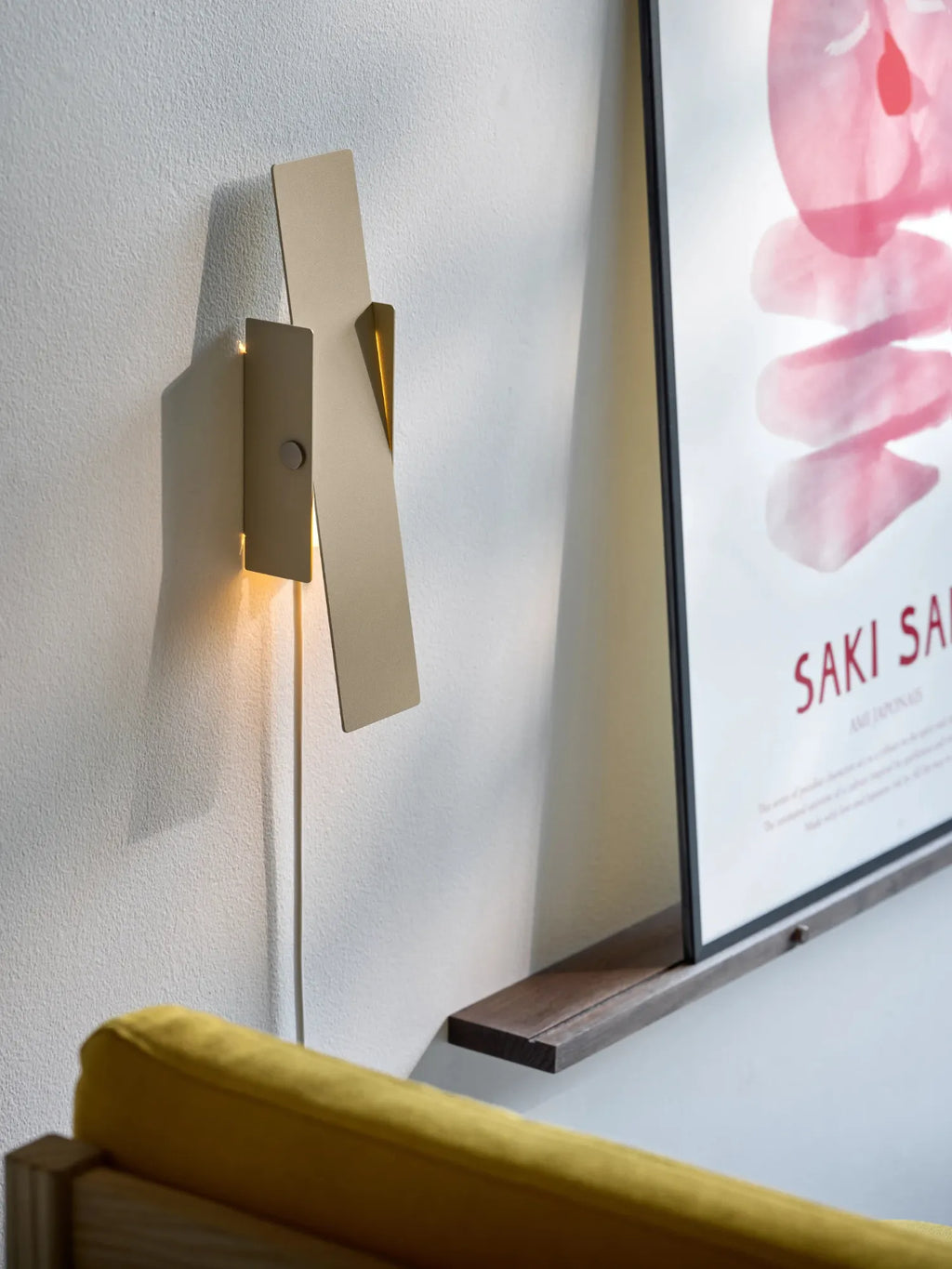 MOEBE Pivoting Wall Lamp, a sleek modern minimalist wall sconce featuring two overlapping matte beige metal panels with a clean geometric design.