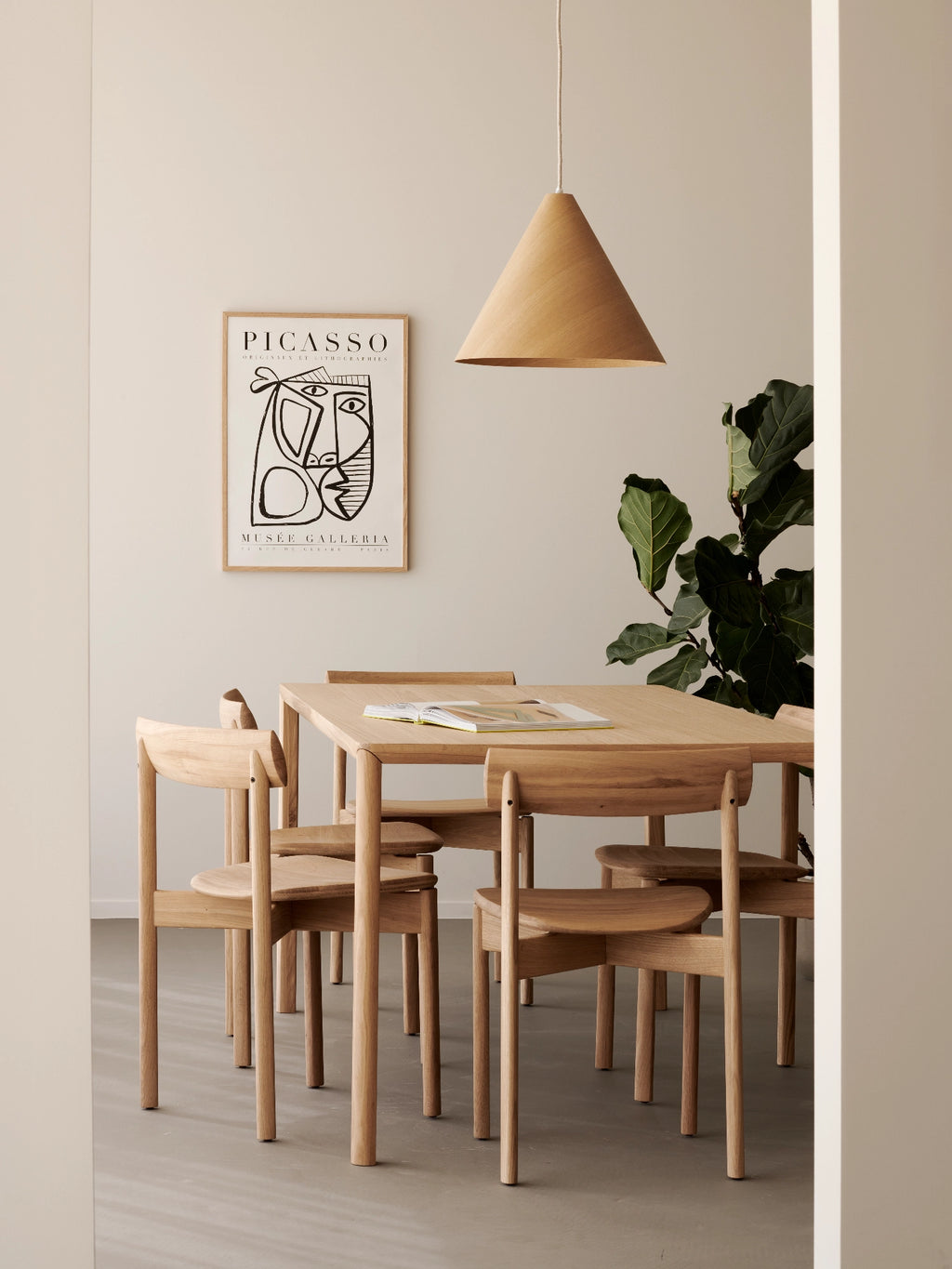 Ethnicraft Risu Dining Chair, a minimalist solid oak dining chair with a natural light wood finish, featuring a gently curved backrest, rounded edges, and a subtly scooped seat for comfort. Its clean lines and sturdy construction embody Scandinavian and Japandi design principles, making it perfect for modern dining rooms, minimalist kitchens, or organic modern living spaces.