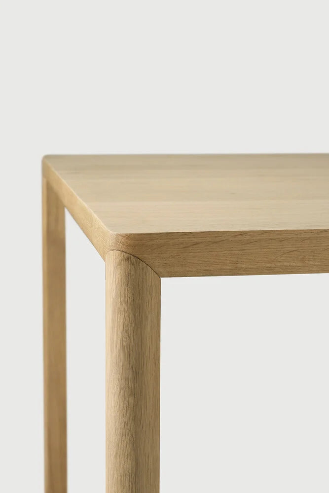 Ethnicraft Air Dining Table, a sleek modern minimalist dining table crafted from solid oak with a light natural wood finish. It features a rectangular tabletop with softly rounded corners and smooth, subtly curved legs, showcasing a clean Scandinavian design. Ideal for contemporary dining rooms, japandi interiors, or a minimalist kitchen table.
