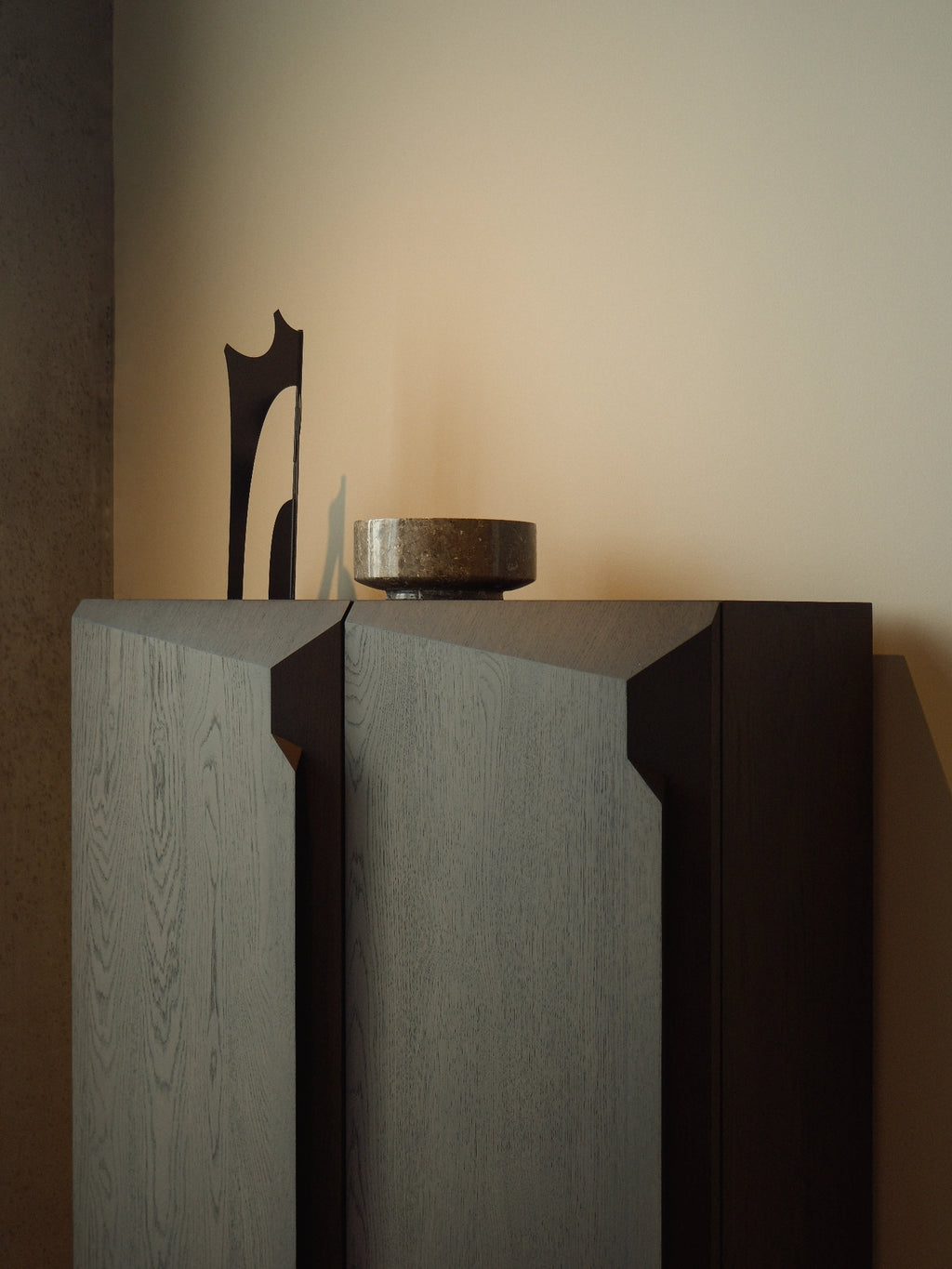 Ethnicraft Stairs Cupboard, a striking modern storage cabinet crafted from dark grey solid wood with a visible textured grain.