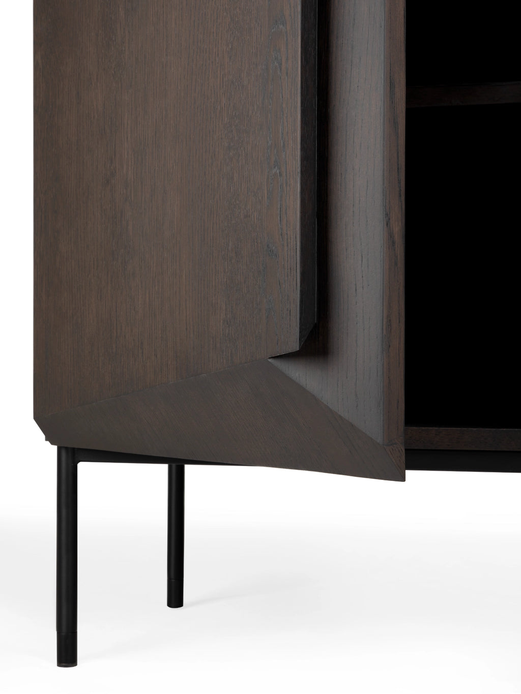 Ethnicraft Stairs Cupboard, a modern dark stained solid oak cabinet featuring a unique geometric faceted door design and sleek matte black metal legs.