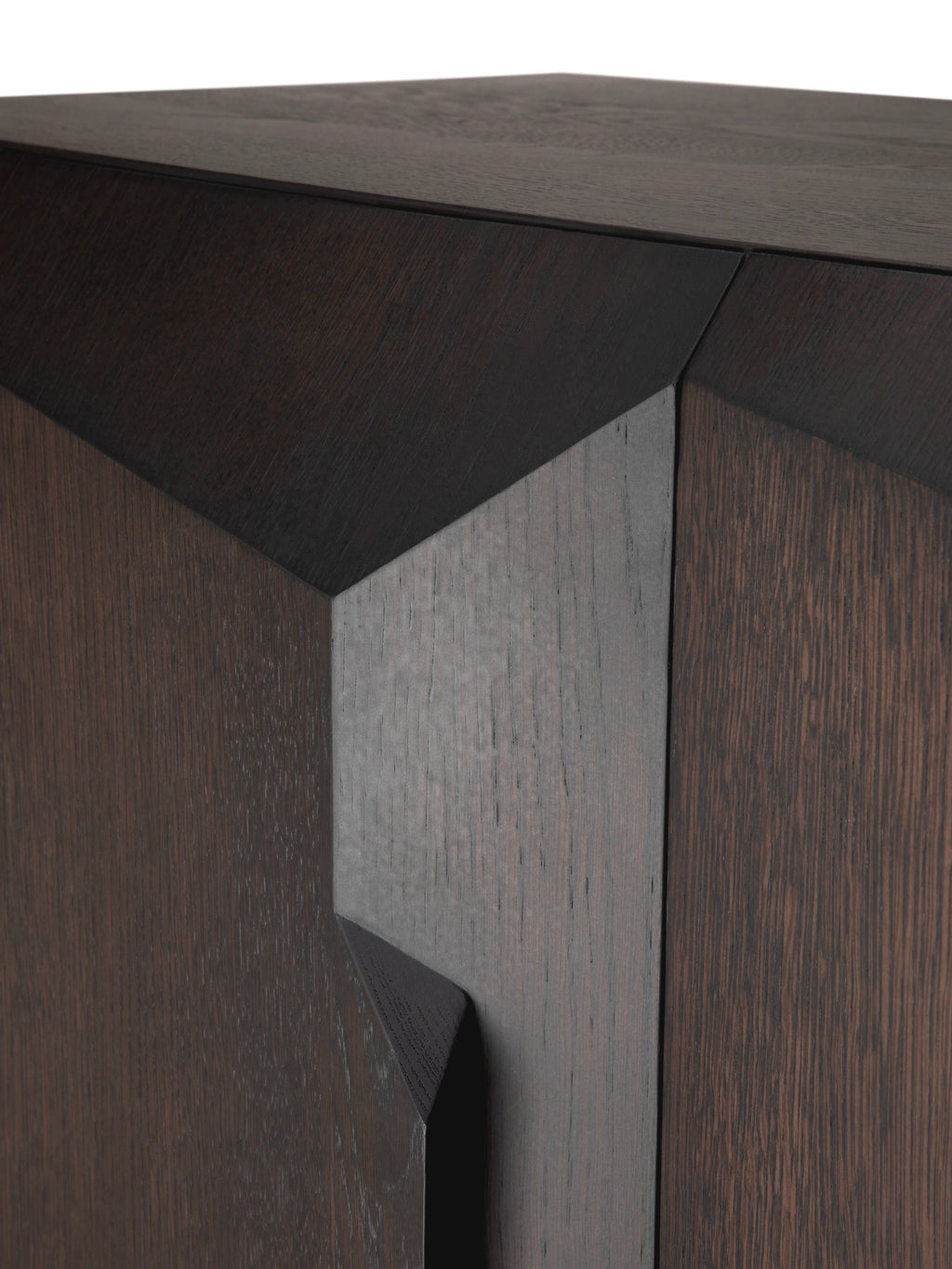 Ethnicraft Stairs Cupboard, a contemporary solid oak cabinet featuring a striking dark stained finish and a bold geometric faceted design with deep, angular relief and natural wood grain variations. This architectural and minimalist storage furniture piece is ideal for modern living rooms, elegant dining spaces, or sophisticated entryways.