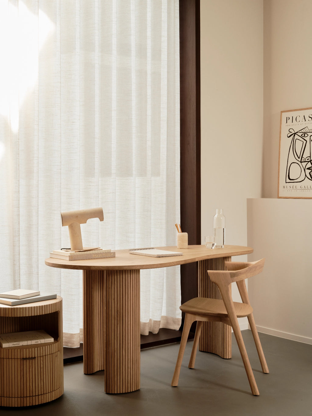 Ethnicraft Boomerang Drawer Unit, a round solid oak fluted drawer unit with a natural light oak finish, featuring an open shelf and a discreet pull-out drawer. This organic modern side table is perfect as a Japandi bedside table or contemporary accent storage for living rooms.