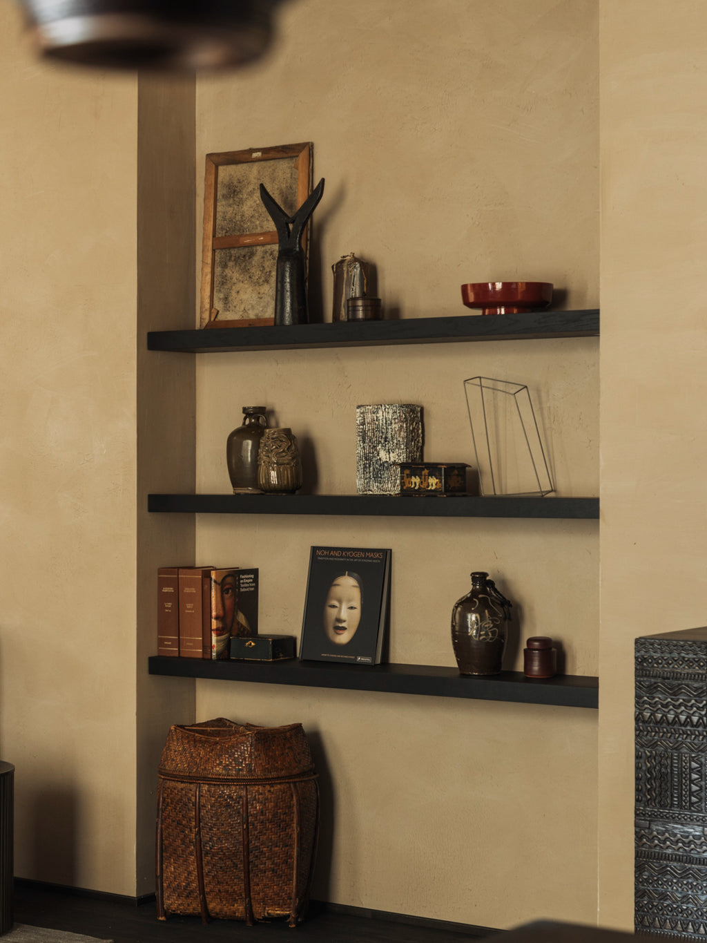 Ethnicraft Wall Shelf, a dark solid wood floating shelf with a sleek, minimalist design, seamlessly integrated into a recessed wall niche. These contemporary display shelves offer a stylish platform for curated home decor, perfect for living room accent walls or modern minimalist interiors.