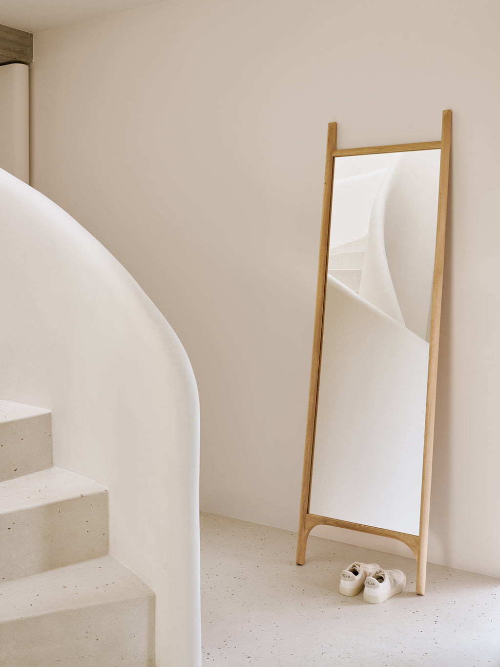 Ethnicraft PI Floor Mirror, a minimalist full-length mirror featuring a solid natural oak wood frame with a unique leaning design and smooth, rounded edges. Its clean lines and warm oak finish make it perfect as a Scandinavian floor mirror for a modern bedroom, entryway, or dressing room.