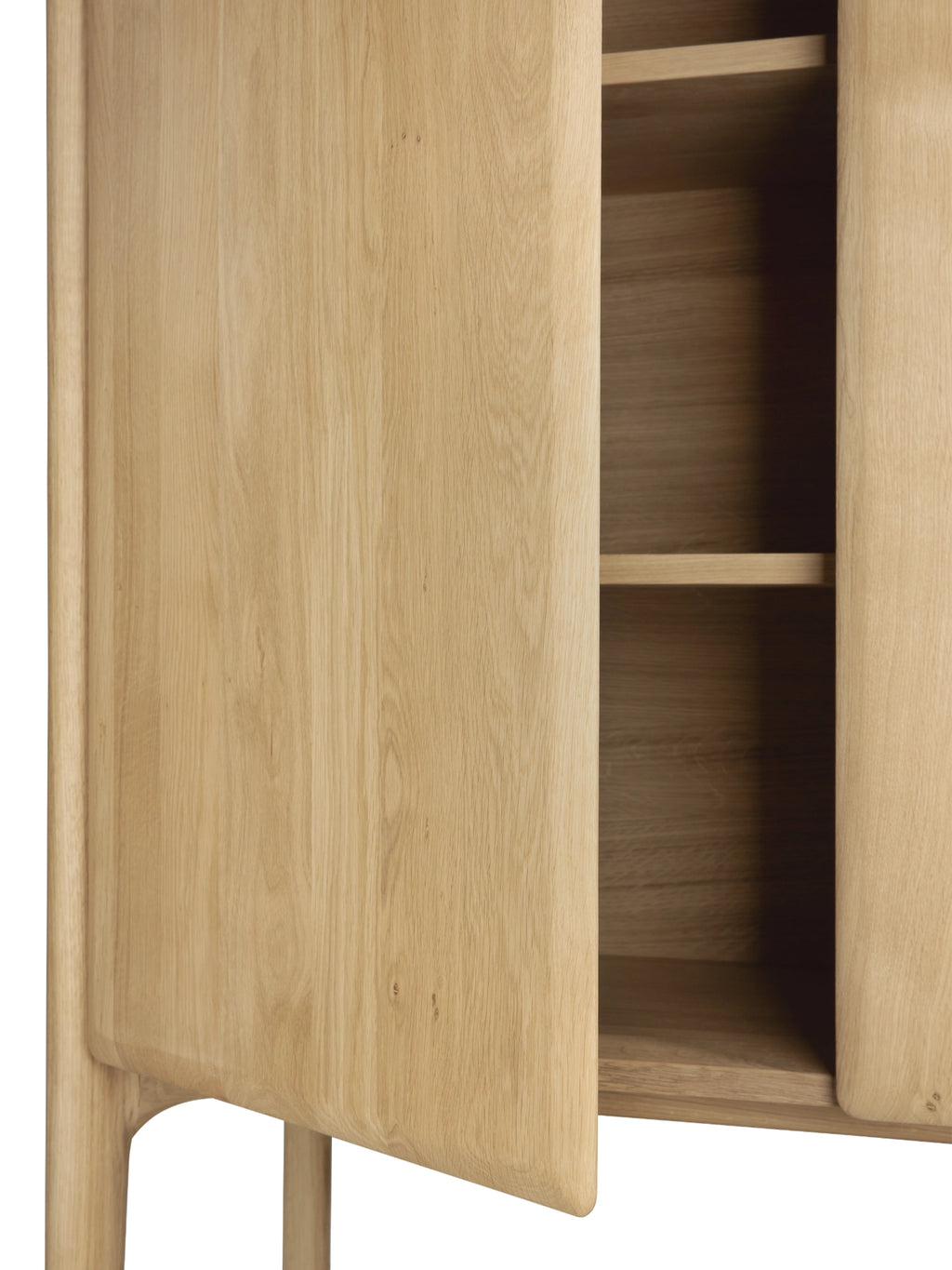 Ethnicraft PI Cupboard, a contemporary solid oak storage cabinet crafted from natural light wood with a smooth grain finish, featuring distinctive soft, rounded edges on its doors and integrated handles, revealing ample internal shelving. This organic modern oak cupboard is perfect for minimalist living rooms, Scandinavian dining rooms, or as versatile storage in any design-conscious interior.