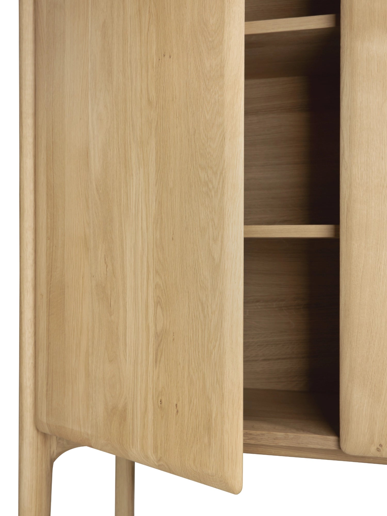 Ethnicraft PI Cupboard, a contemporary solid oak storage cabinet crafted from natural light wood with a smooth grain finish, featuring distinctive soft, rounded edges on its doors and integrated handles, revealing ample internal shelving. This organic modern oak cupboard is perfect for minimalist living rooms, Scandinavian dining rooms, or as versatile storage in any design-conscious interior.
