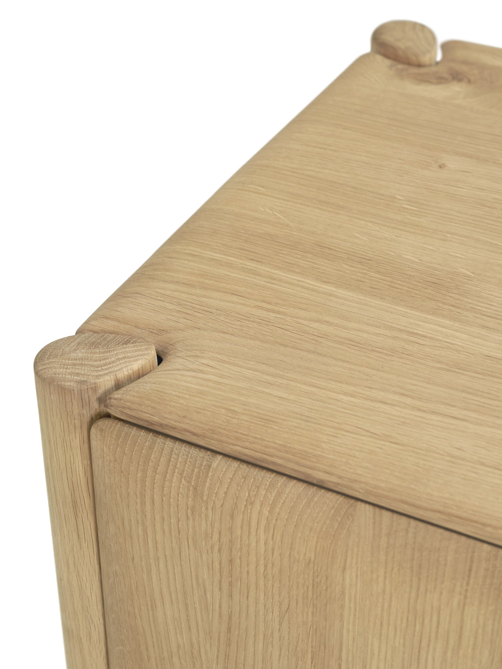 Ethnicraft PI Cupboard, a minimalist solid oak wood storage cabinet featuring a natural light oak finish with a visible wood grain and distinctive rounded exposed joinery detail on the corners. This Scandinavian-inspired piece combines organic modern design with expert craftsmanship, creating a warm and functional accent. Ideal for living room storage, a bedroom side table, or an entryway console in contemporary or Japandi interiors.