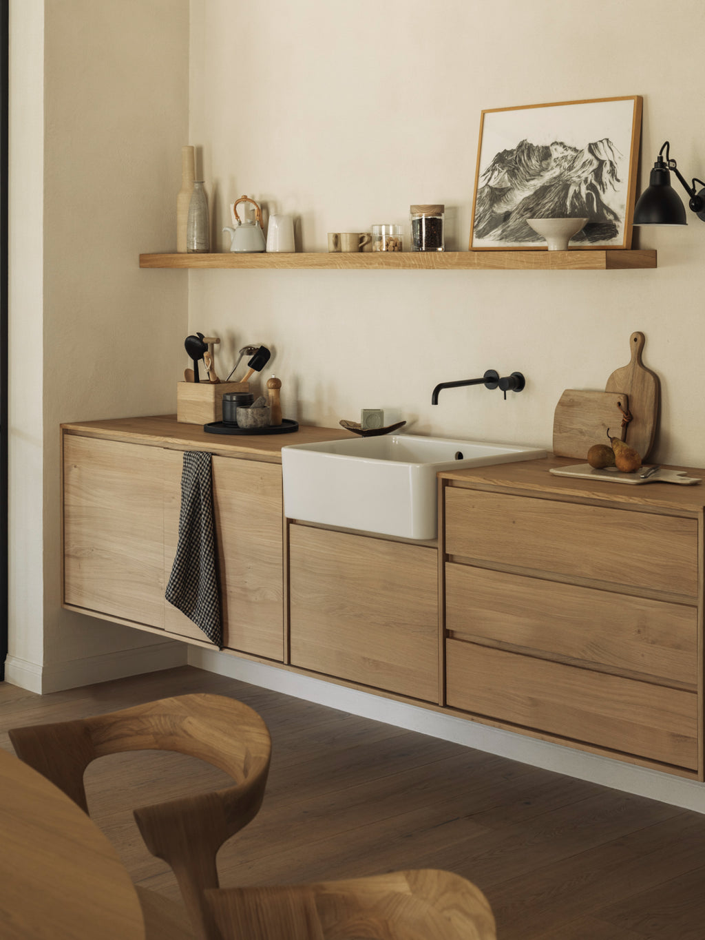 Ethnicraft Wall Shelf, a minimalist solid oak floating shelf crafted from natural light wood with a smooth finish and subtle grain, providing a clean, contemporary storage solution. This versatile wooden shelf is perfect for adding Scandinavian style to modern kitchens, living rooms, or home office spaces.