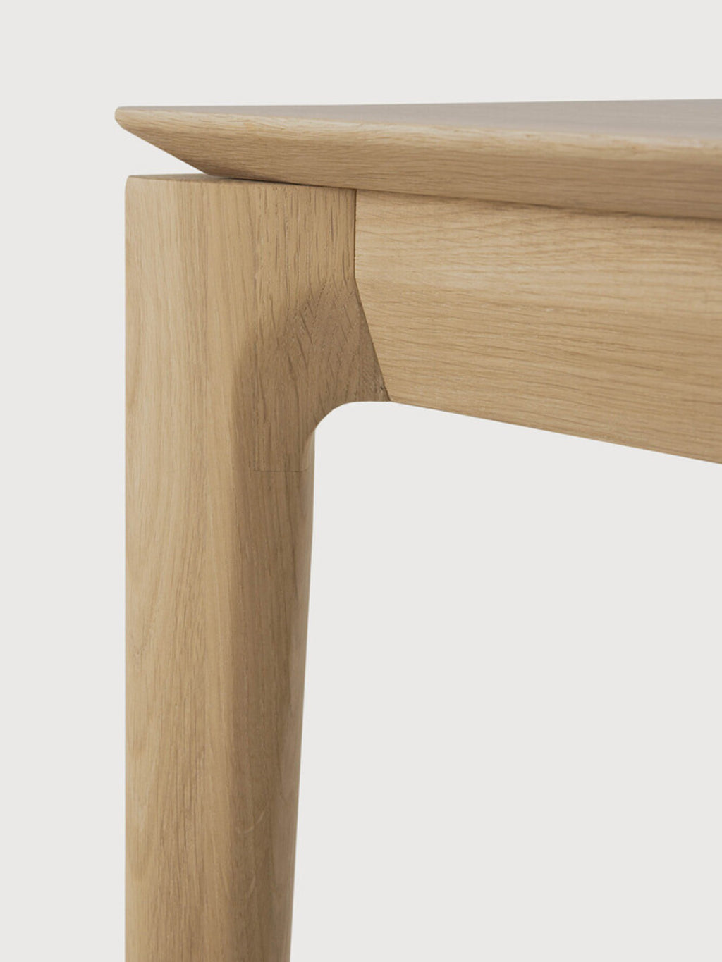 Ethnicraft Bok Bench, a modern minimalist solid oak bench featuring a natural light wood finish with visible grain and distinctive sculpted legs that seamlessly join the rectangular top. This Scandinavian-inspired piece offers clean lines and an organic silhouette, perfect as a dining bench, entryway seating, or a versatile accent in contemporary living spaces.