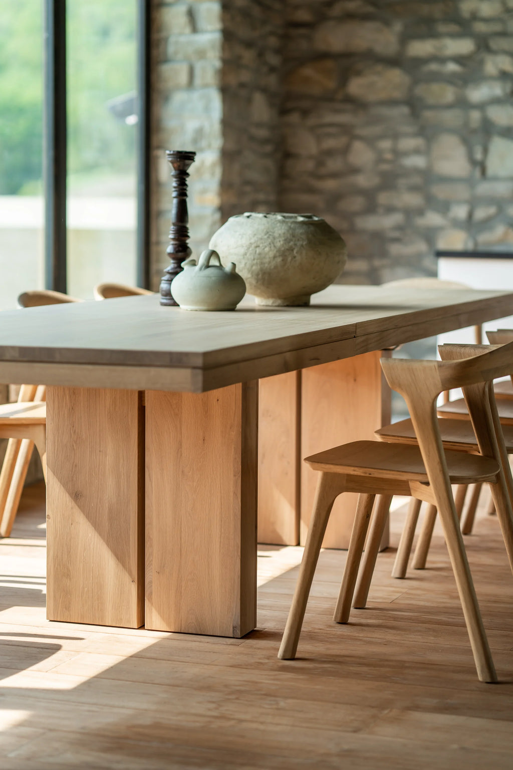 Ethnicraft Double Extendable Dining Table, a modern minimalist dining table crafted from natural solid oak wood with a smooth, light grain finish, featuring a rectangular tabletop and sturdy block legs.