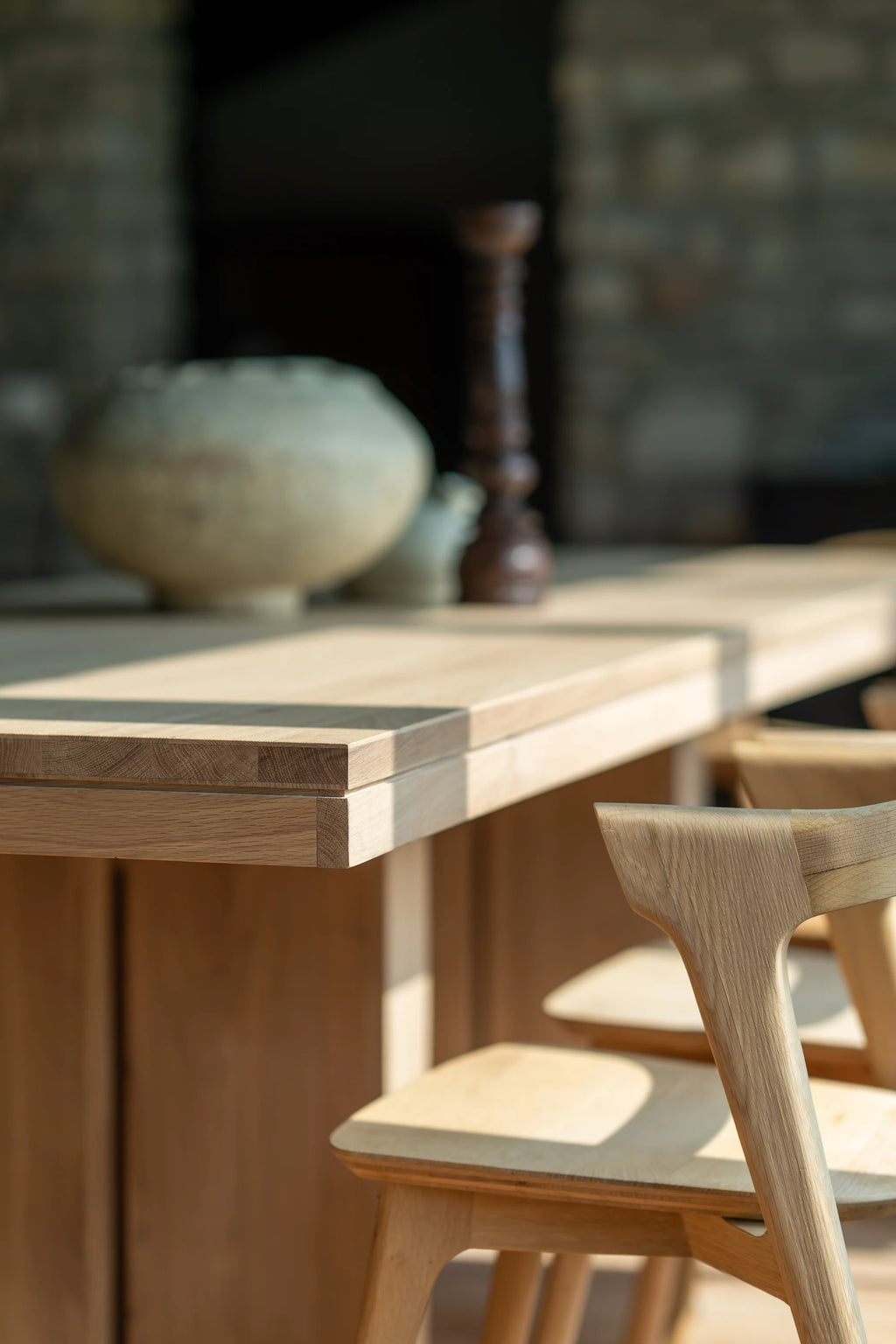 Ethnicraft Double Extendable Dining Table, a contemporary extendable dining table crafted from light natural solid oak wood, featuring visible grain, clean lines, and a smooth finish. Its clever double extendable design allows for versatile seating arrangements, showcasing precise joinery and a warm, inviting aesthetic. Ideal for modern minimalist dining rooms, Scandinavian interiors, or versatile open-plan living spaces.