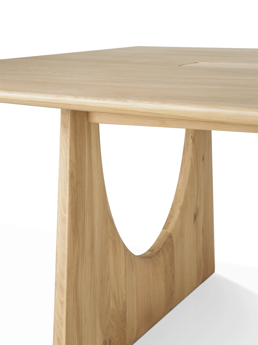 Ethnicraft Geometric Meeting Table, a contemporary solid oak dining table crafted with a light natural oak finish, featuring a rectangular tabletop with softly rounded edges.