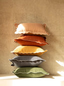 Stack of colorful pillows on a beige background