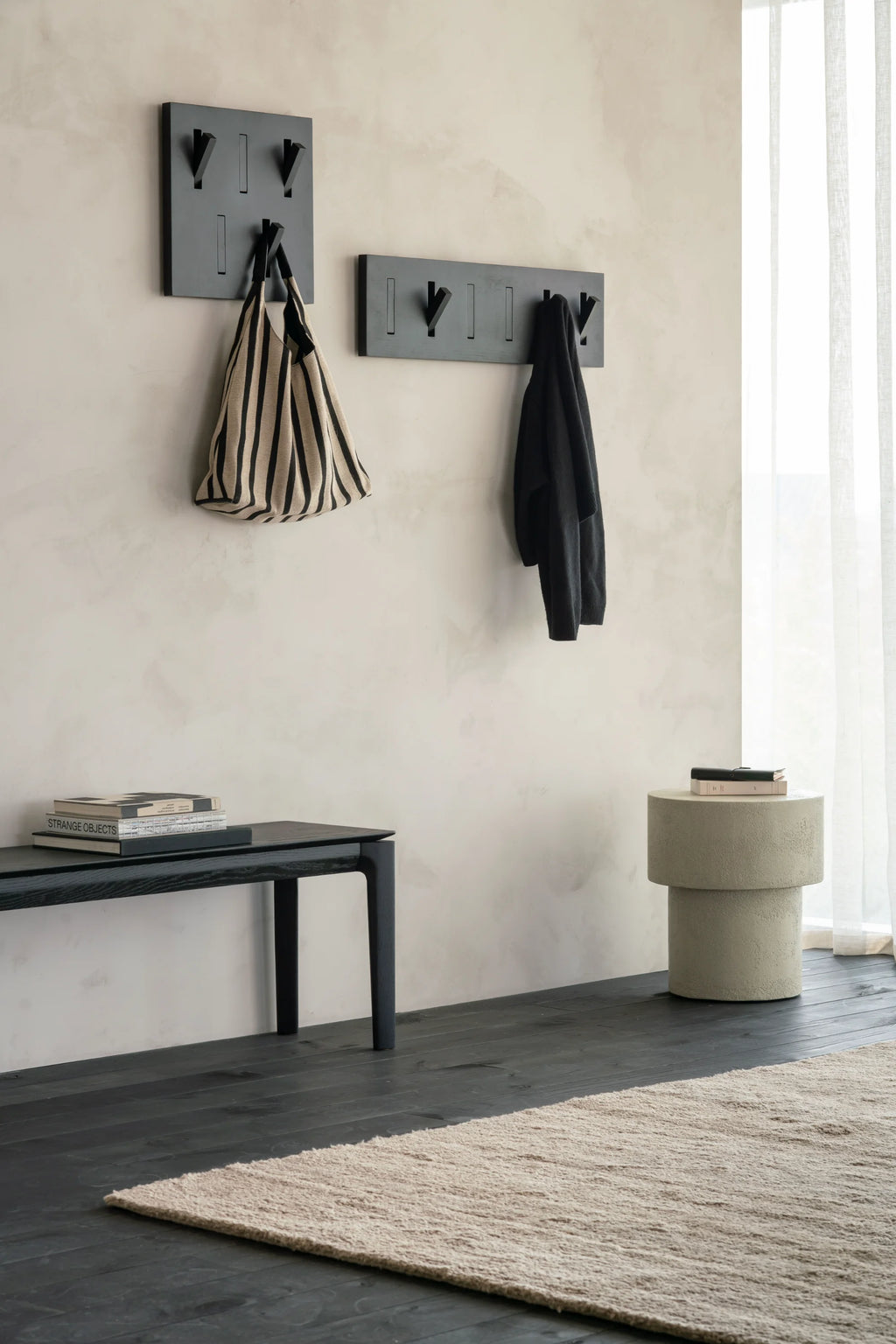 Ethnicraft Elements Side Table, a contemporary organic modern side table crafted from durable textured concrete with a warm greige finish. Its unique stacked cylindrical shape creates a sculptural, brutalist-inspired form, offering a substantial yet minimalist aesthetic. Perfect as an accent table for living rooms, a bedside table, or a stylish entryway console in modern homes.