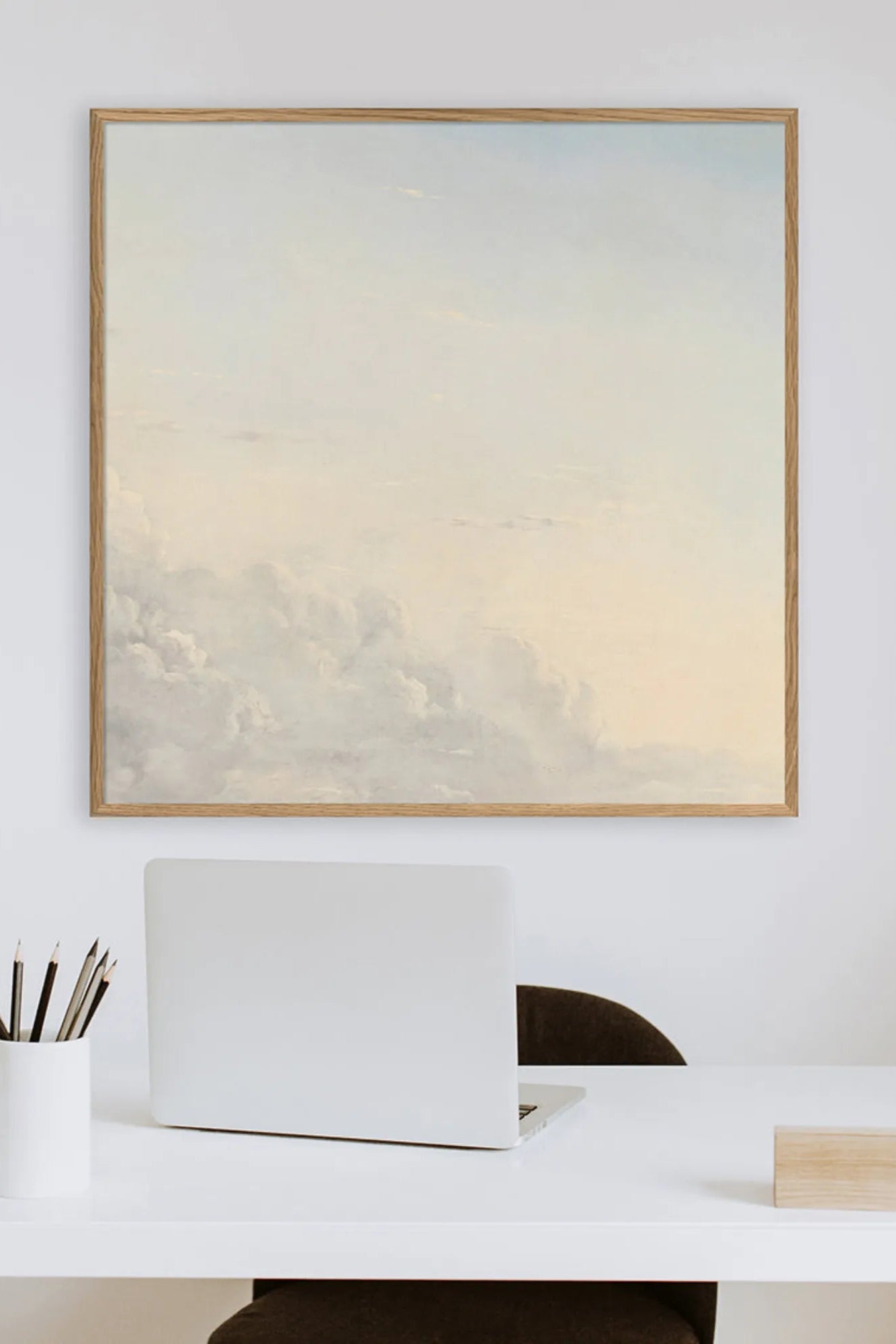 Large canvas art depicting fluffy clouds in shades of grey and blue