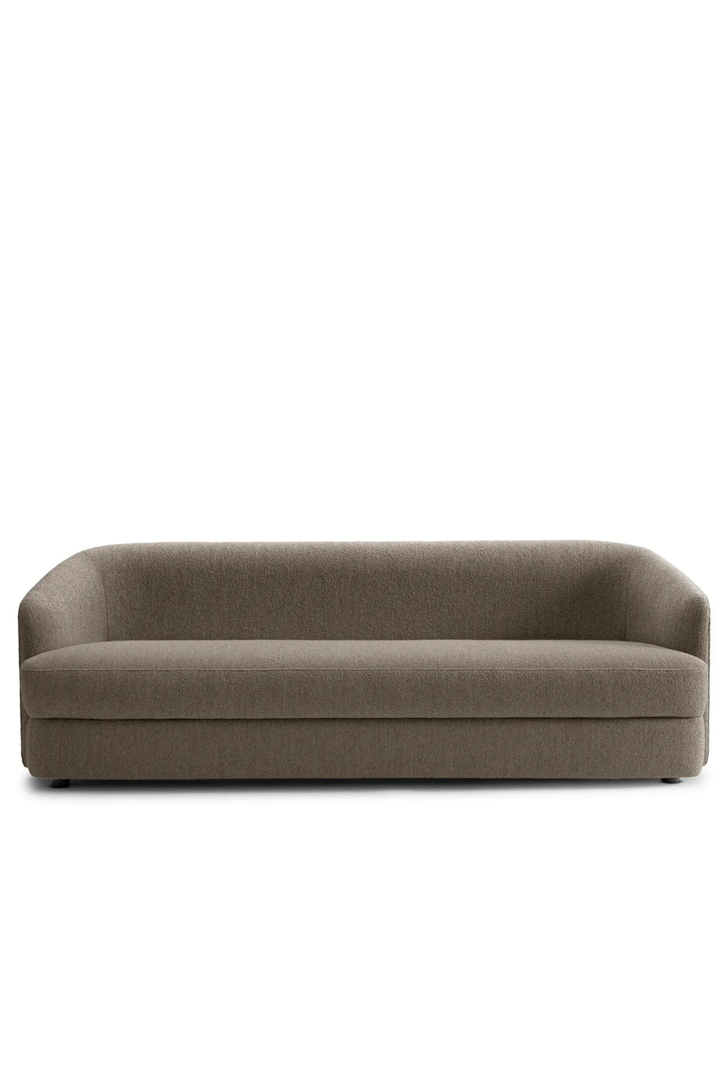 New Works Covent Sofa Deep 3-Seater, a contemporary upholstered sofa featuring a deep, comfortable seat and a gracefully curved backrest and armrests, all seamlessly integrated into a low-profile,.