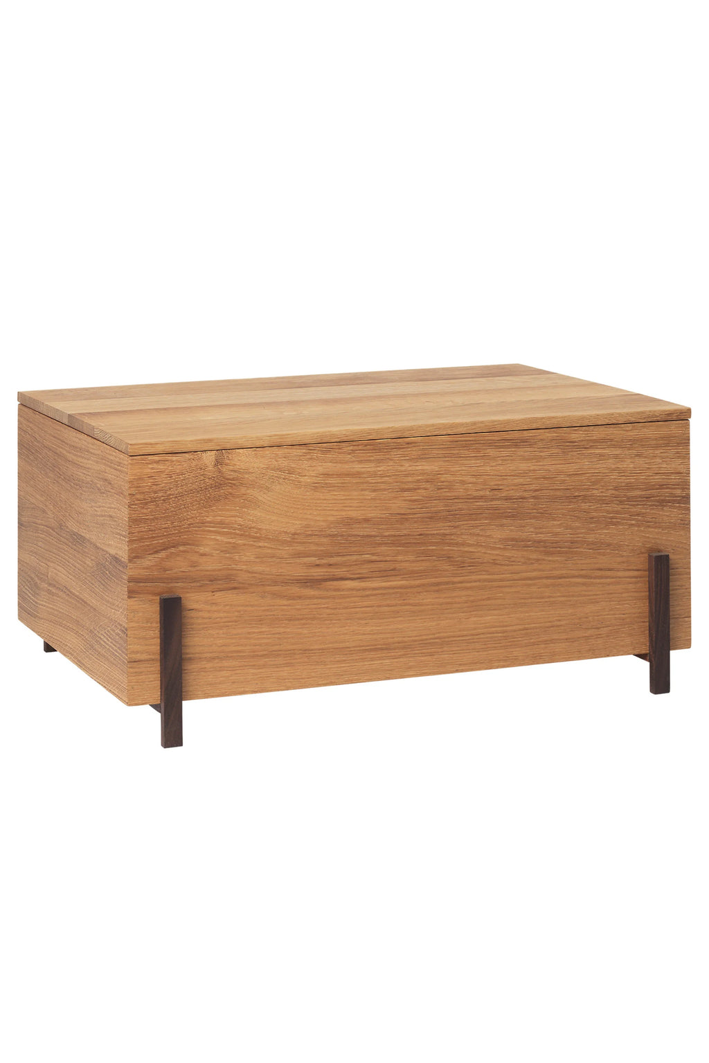 Kristina Dam Stack Storage Box, a modern minimalist storage box crafted from natural solid oak wood with a clean rectangular silhouette. It features a lift-off lid and is elevated on sleek, contrasting dark brown wooden legs, showcasing a contemporary Scandinavian design. Ideal for stylish storage in a living room, entryway, or bedroom, blending seamlessly with organic modern interiors.