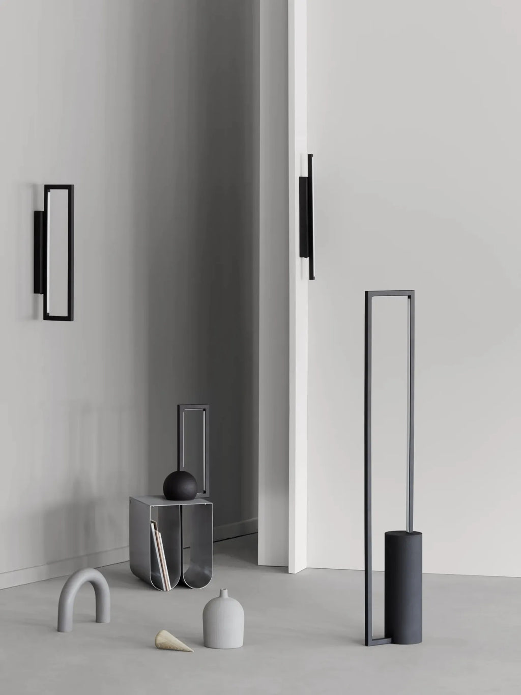 Kristina Dam Geometric Wall Lamp, a sleek modern minimalist wall light crafted from matte black metal with a striking rectangular frame and an integrated linear LED panel. This contemporary Scandinavian wall sconce provides ambient lighting for sophisticated interiors. Ideal for hallways, living rooms, or as a modern bedroom accent.
