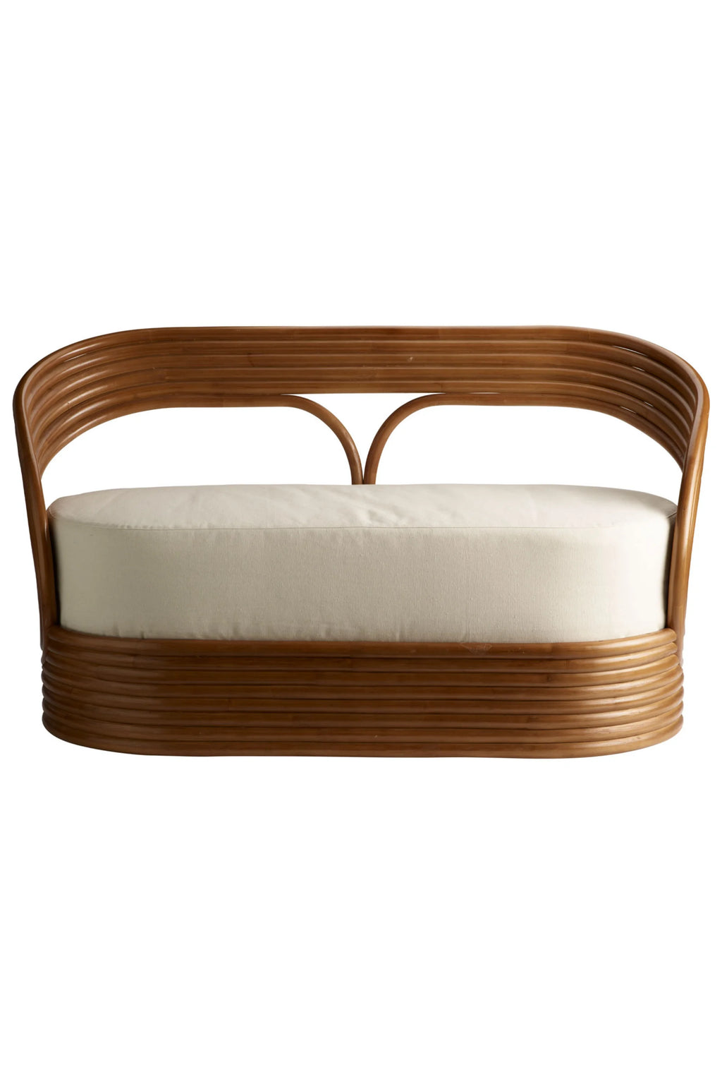 Tine K Mano Sofa, a stylish organic modern settee featuring a beautifully curved natural bent rattan frame in a warm caramel brown finish, with a plush, removable cream upholstered cushion. This eye-catching rattan sofa offers a relaxed bohemian or coastal aesthetic, perfect for a living room, entryway, or sunroom.