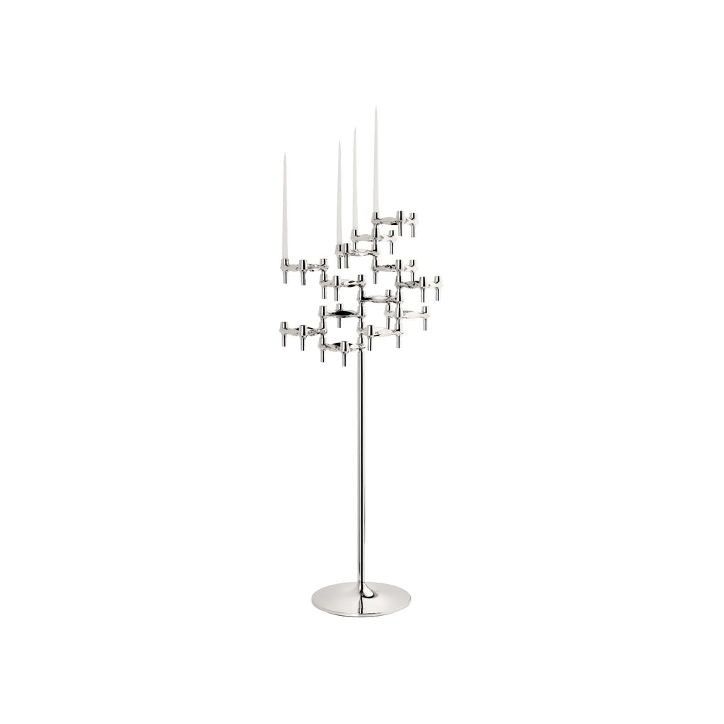 Stoff Nagel BMF Candle Holder Floor Stand - Configuration 2, a striking mid-century modern chrome floor candelabra featuring a modular, interlocking design of polished silver metal candle holders arranged in a sculptural cluster on a slender stand with a round base. This tall metal floor candle holder creates a dynamic, architectural display with its Brutalist-inspired, stackable units. It's perfect for making a contemporary design statement in a living room, dining room, or modern entryway.