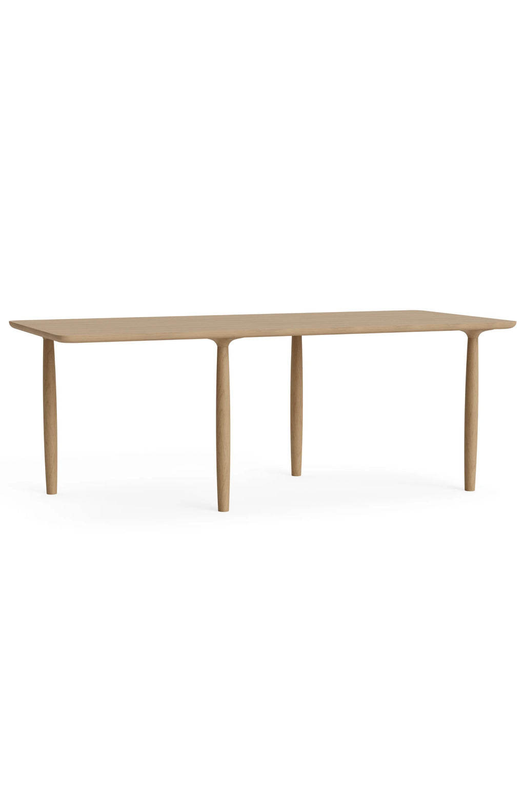 NORR11 Oku Rectangle Dining Table, a modern minimalist dining table crafted from natural light oak wood. It features a sleek rectangular tabletop with subtly rounded corners and four elegantly tapered, solid wood legs that seamlessly connect to the table surface, showcasing an organic modern design. This Scandinavian-inspired oak dining table is perfect for contemporary dining rooms or spacious kitchen areas, offering both style and functionality.