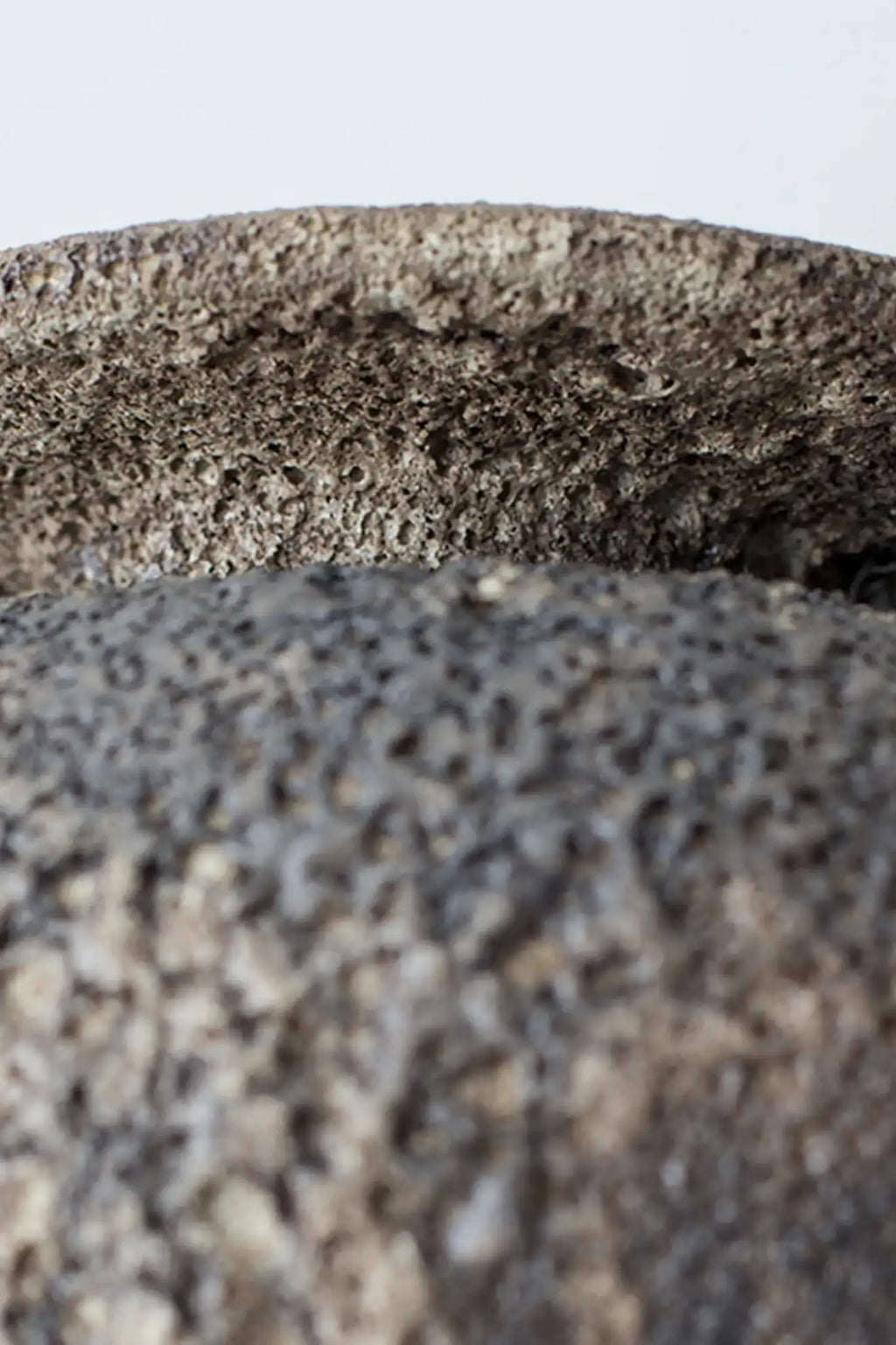 Canoa Lab Isolated n.7 Vase, a handcrafted dark grey ceramic vase with an intensely porous, volcanic texture and a raw, brutalist finish, showcasing natural charcoal and earthy tones.