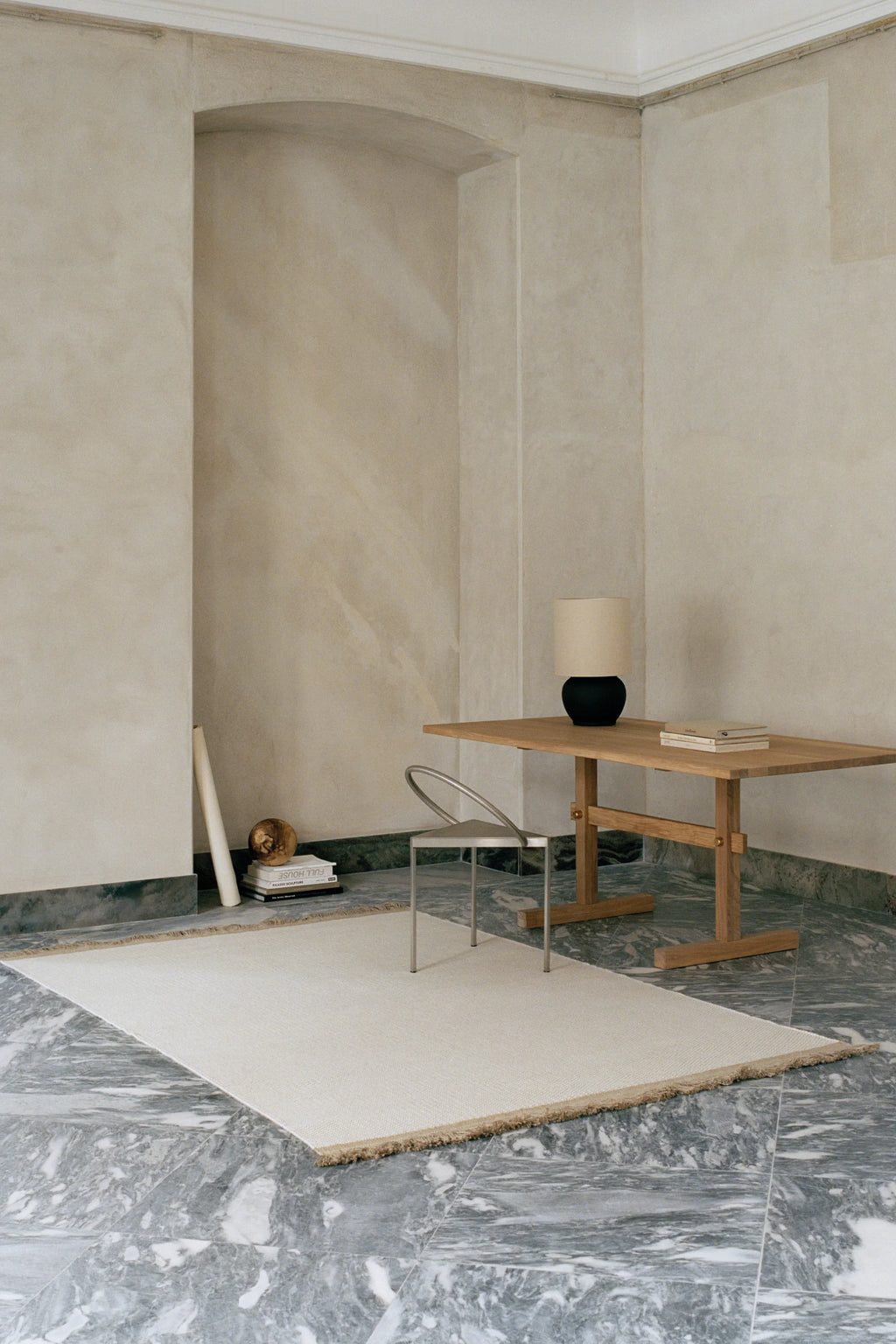 Linie Design Pastoral Unity Wool Rug, a cream-colored natural wool area rug featuring a subtle flatweave texture and delicate beige fringed edges, offering a soft, organic feel. This minimalist design emphasizes natural materials and clean lines. Ideal for creating a serene atmosphere in Scandinavian living rooms, modern minimalist bedrooms, or organic contemporary spaces.