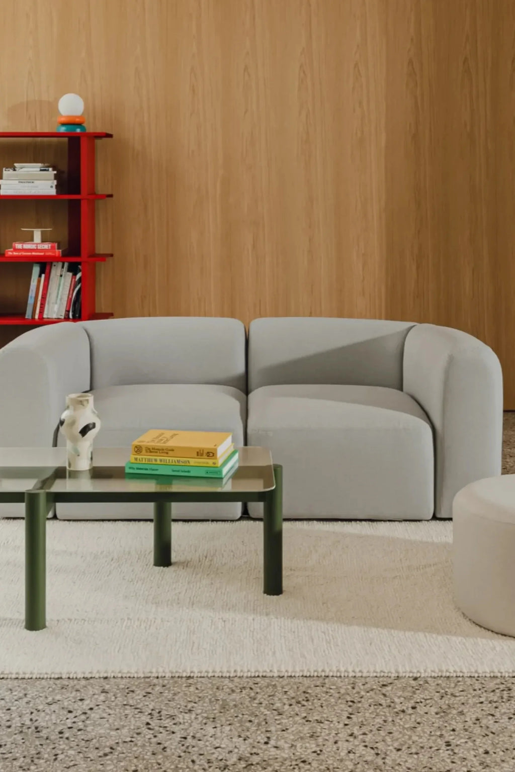 noo.ma Flom 2-Seater Sofa, a modern minimalist sofa upholstered in soft light grey fabric with a plush, subtly textured finish and an inviting organic curved silhouette. Its low-profile design and rounded edges create a cozy yet contemporary feel, offering comfortable seating for two. Ideal as a stylish 2-seater sofa for small living rooms, apartments, or Scandinavian-inspired interiors.